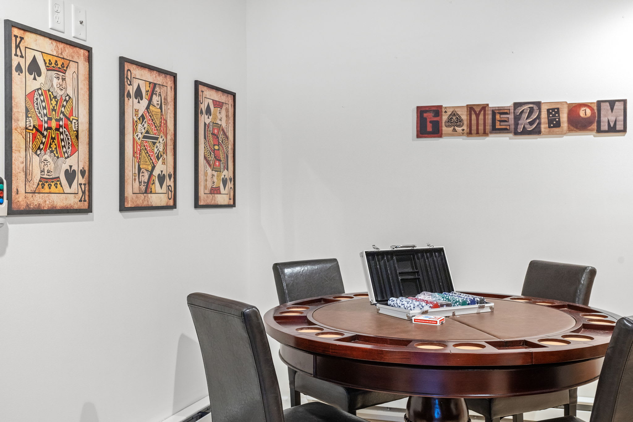 Wall art and a modern game table create a space designed for entertainment, whether it’s poker, board games, or just great conversation.