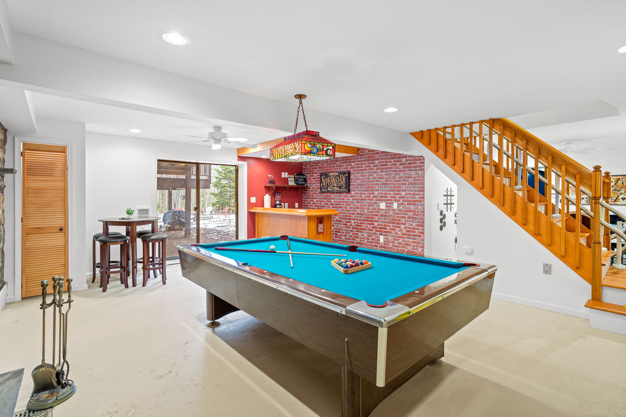 A lively recreation space complete with a pool table and bar seating, making it the go-to area for friendly competition and endless fun.