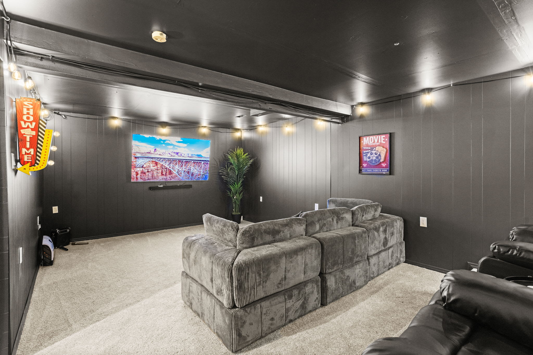 A modern home theater setup with plush seating, dimmed lighting, and a large screen, perfect for movie marathons and cozy nights in.