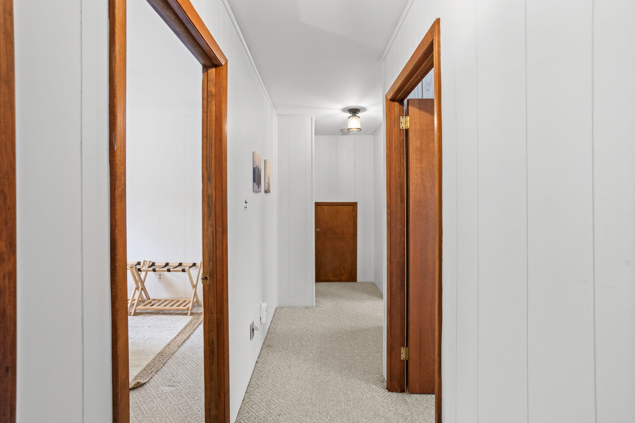 A bright and spacious hallway leading to various rooms, accented with wood finishes and minimalistic decor. The perfect transition space with a clean, modern feel.