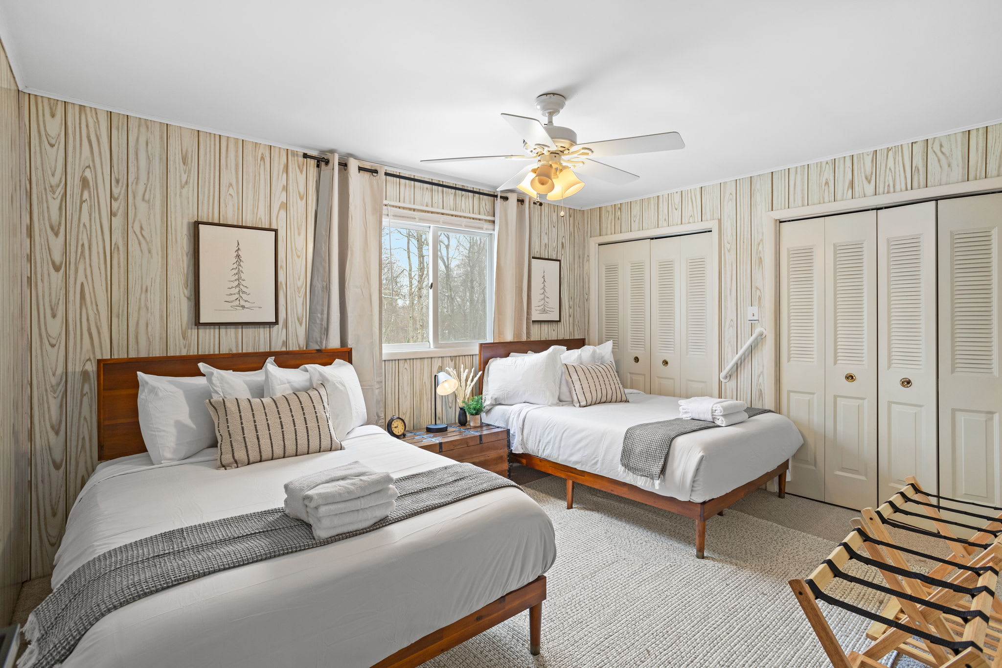 A warm, inviting space with charming wooden details, comfortable beds, and a hint of classic cabin style. (2 Queen Size Bed)