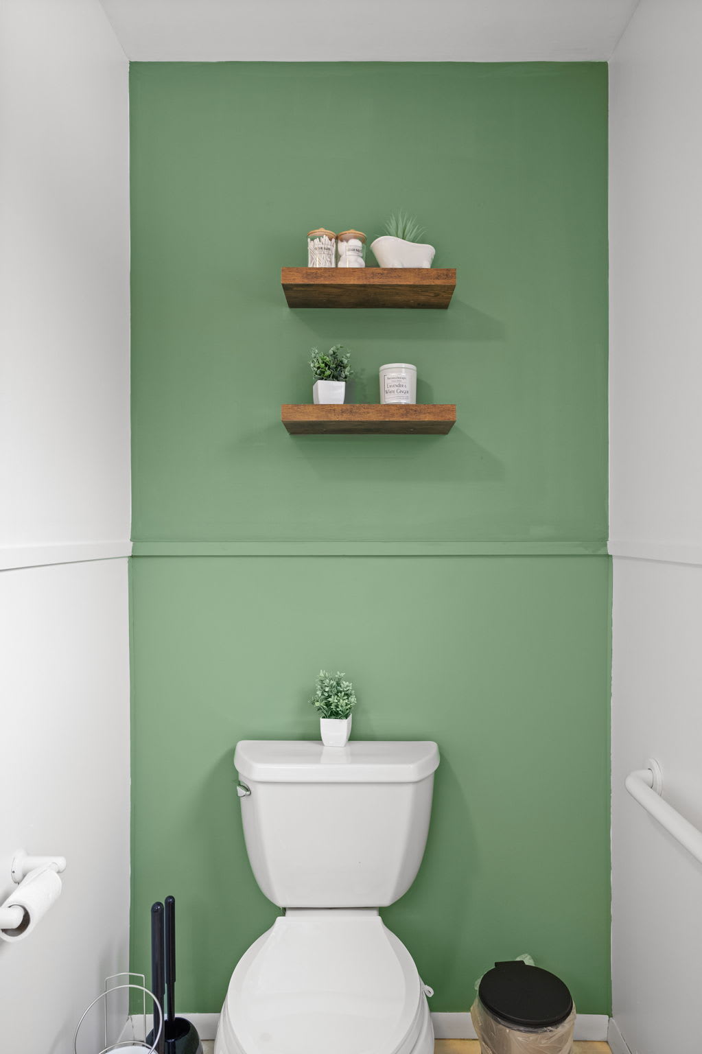 A sleek and stylish touch with a soft green accent wall, open shelving, and a clean modern aesthetic.