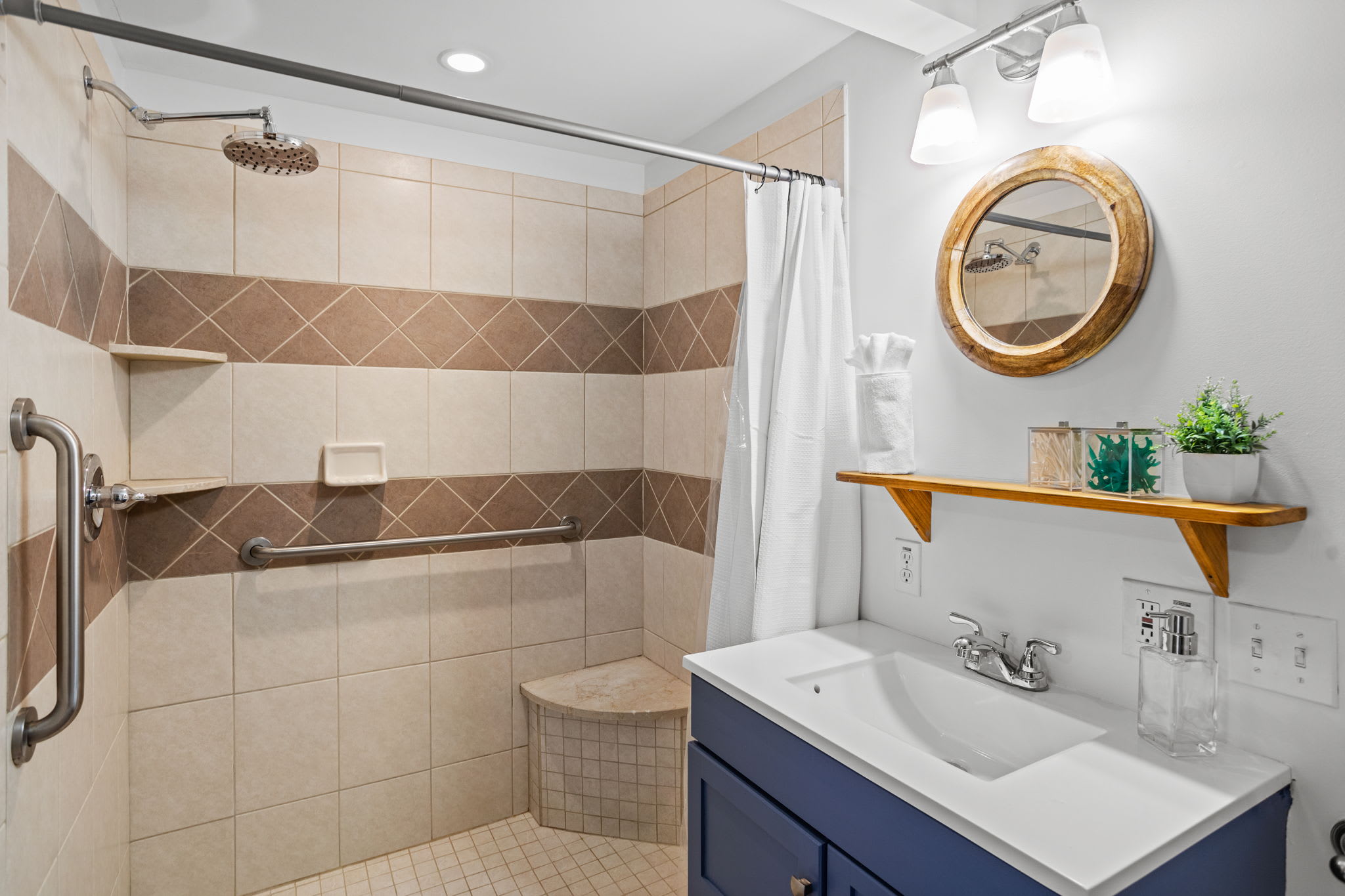 A modern bathroom with a spacious tiled shower, elegant vanity, and soft lighting, designed for ultimate relaxation.