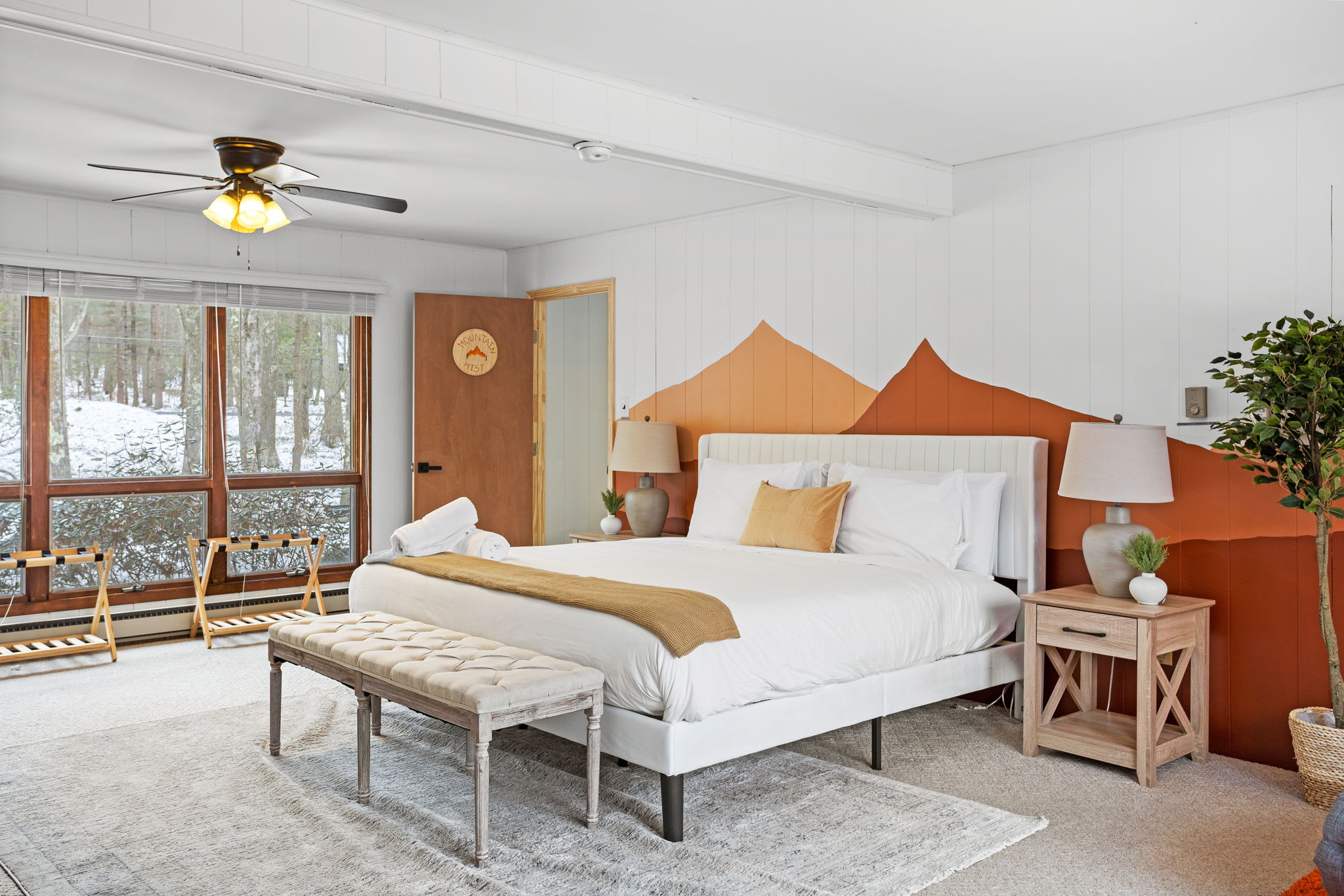 The combination of large windows, wooden accents, and earthy tones makes this bedroom a peaceful and rejuvenating space for guests. (1 King Size Bed)