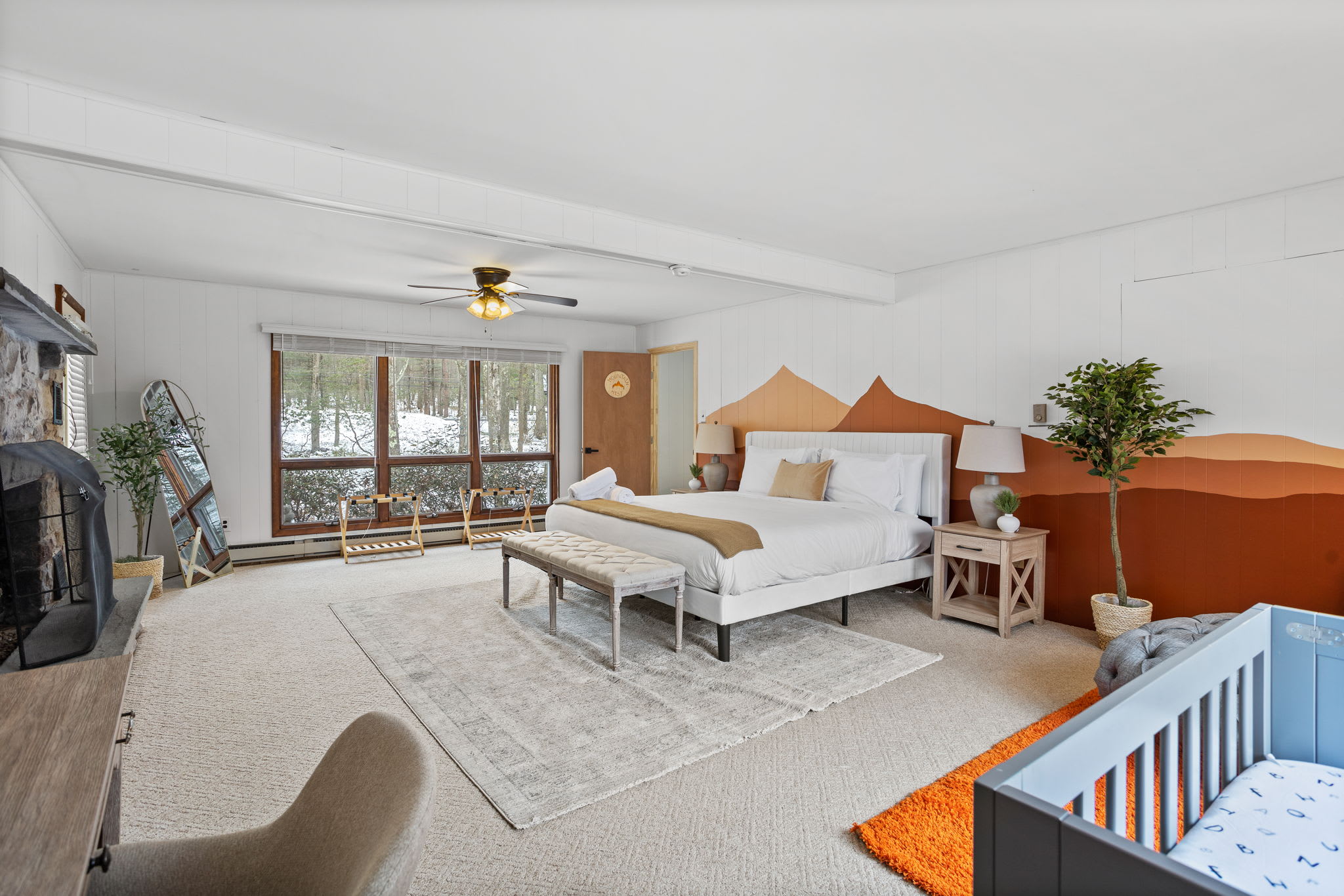 A dreamy bedroom with a fireplace, plush bedding, and elegant decor, designed for ultimate relaxation.