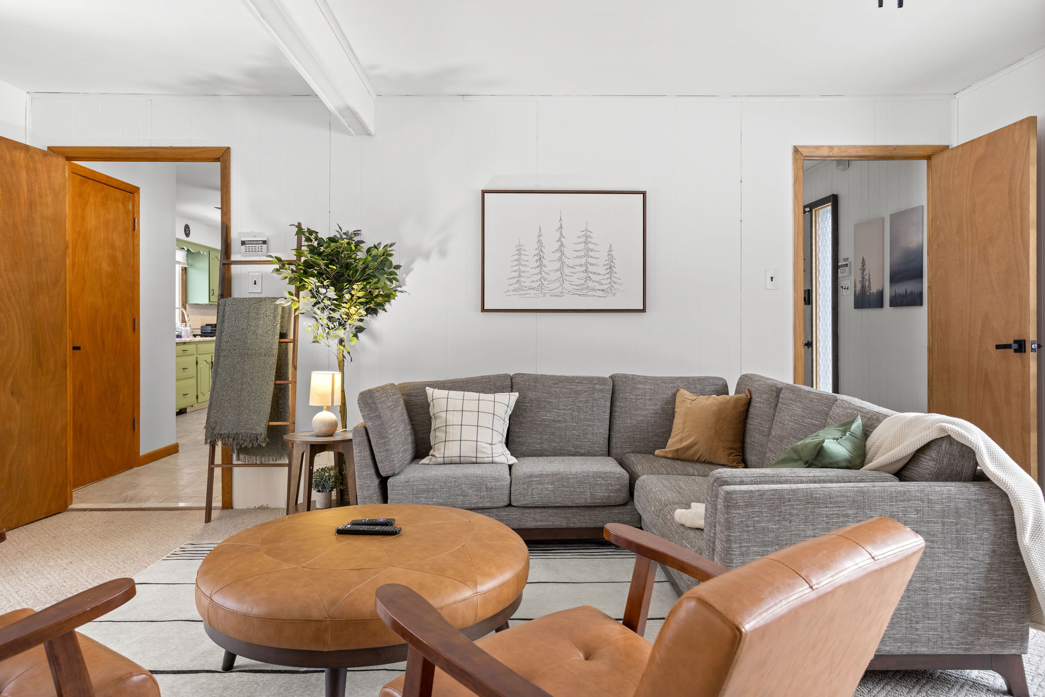 A mix of sleek and earthy tones, with contemporary furniture that blends comfort and sophistication.