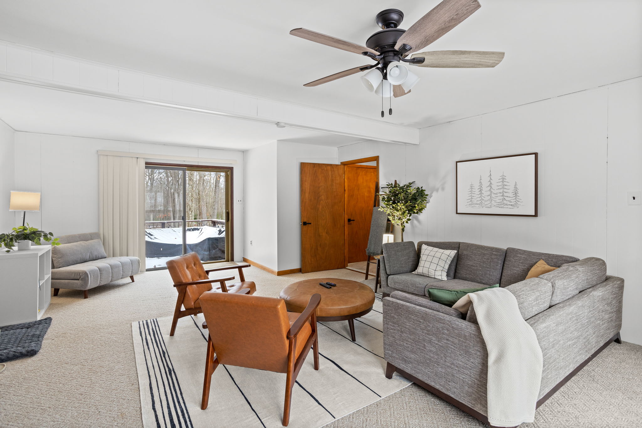 Large windows, a neutral color palette, and plenty of seating make this the ultimate relaxation spot.