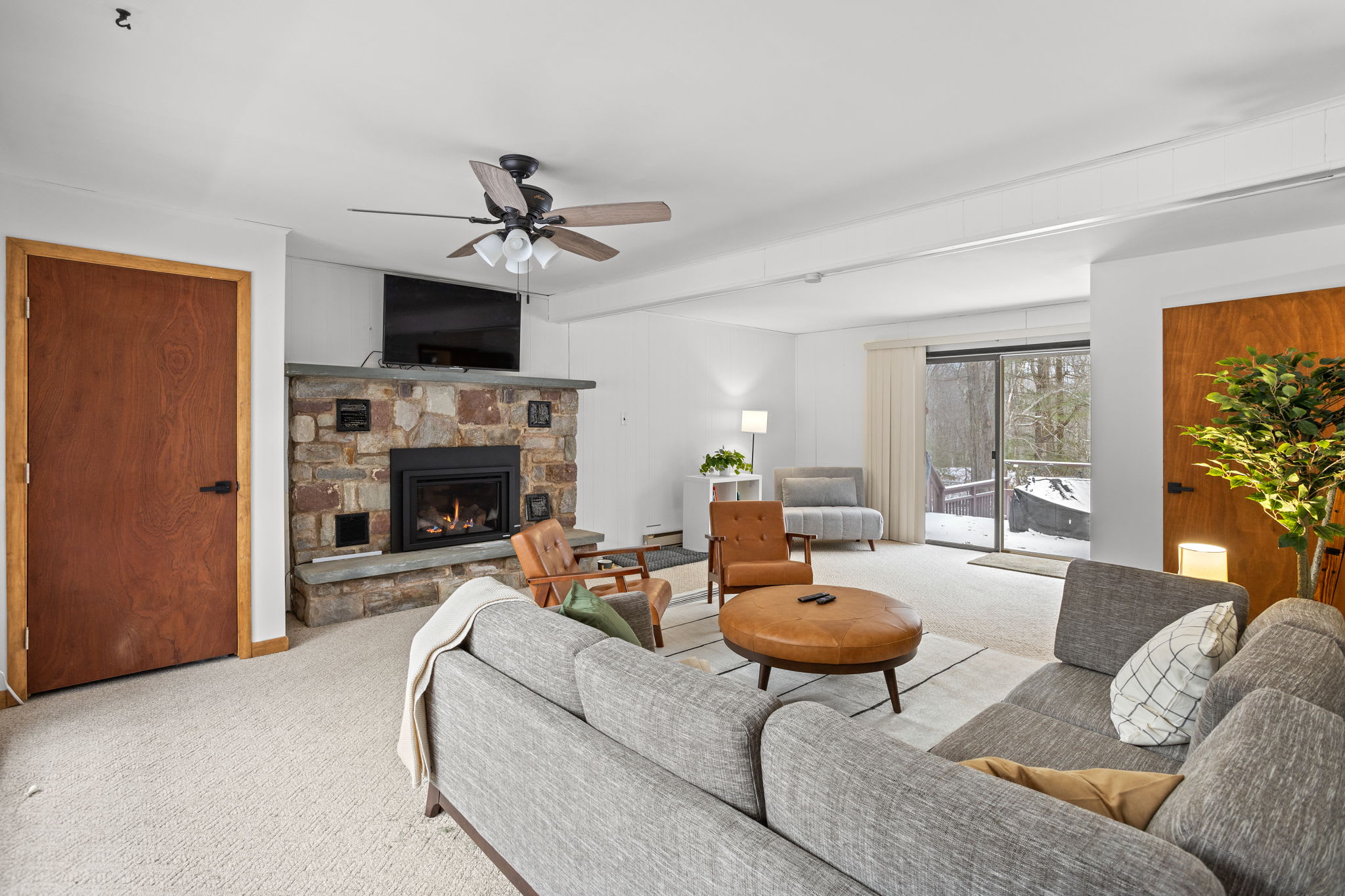 A cozy yet stylish space with modern furniture, soft textiles, and warm lighting, perfect for unwinding.