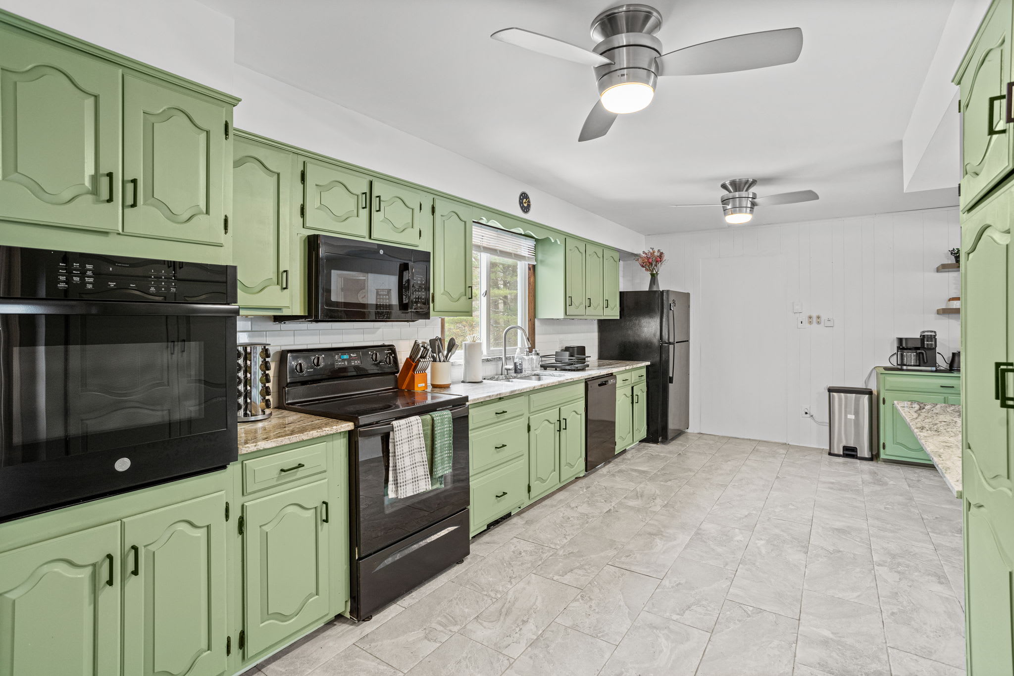 A well-equipped kitchen boasting ample storage, updated appliances, and a fresh, inviting atmosphere.