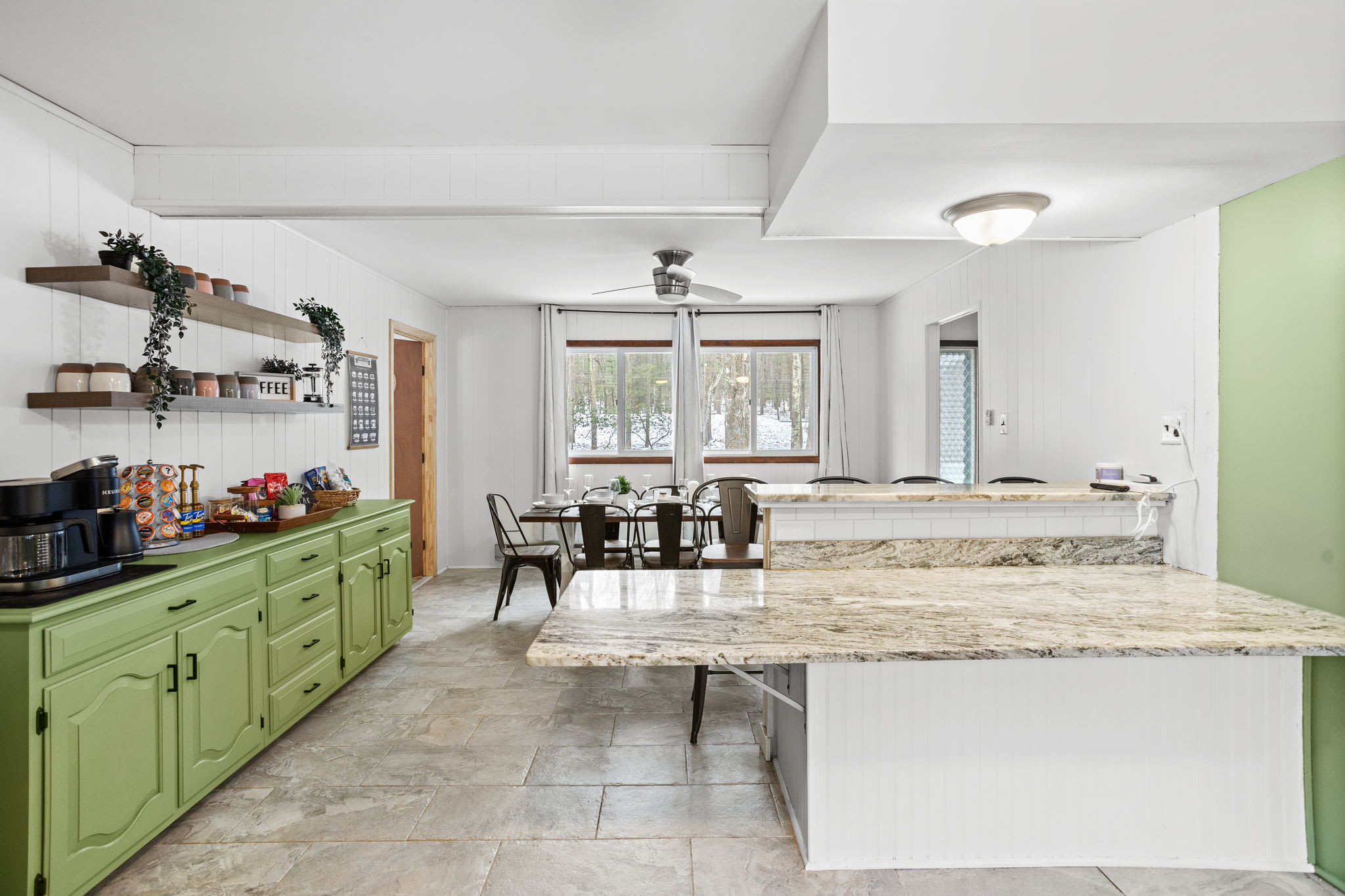 A bright and open kitchen with a large island, perfect for prepping meals and socializing with guests.