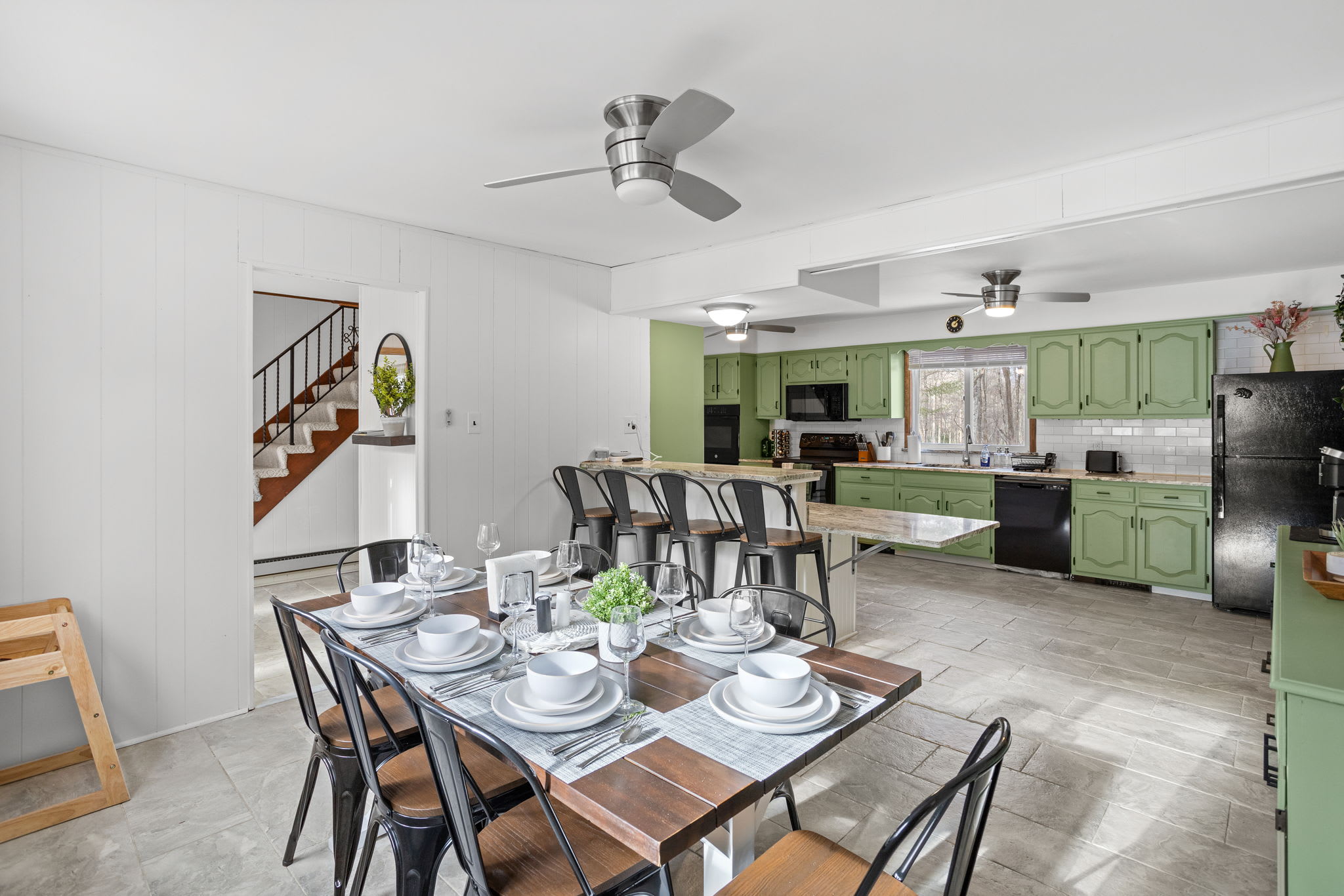  A unique mix of vintage charm and modern convenience, with bold green cabinetry and open shelving.