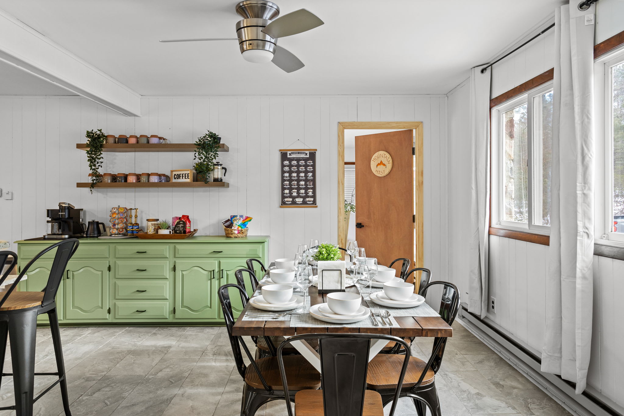 Natural light floods this inviting dining area, where rustic charm meets modern comfort.