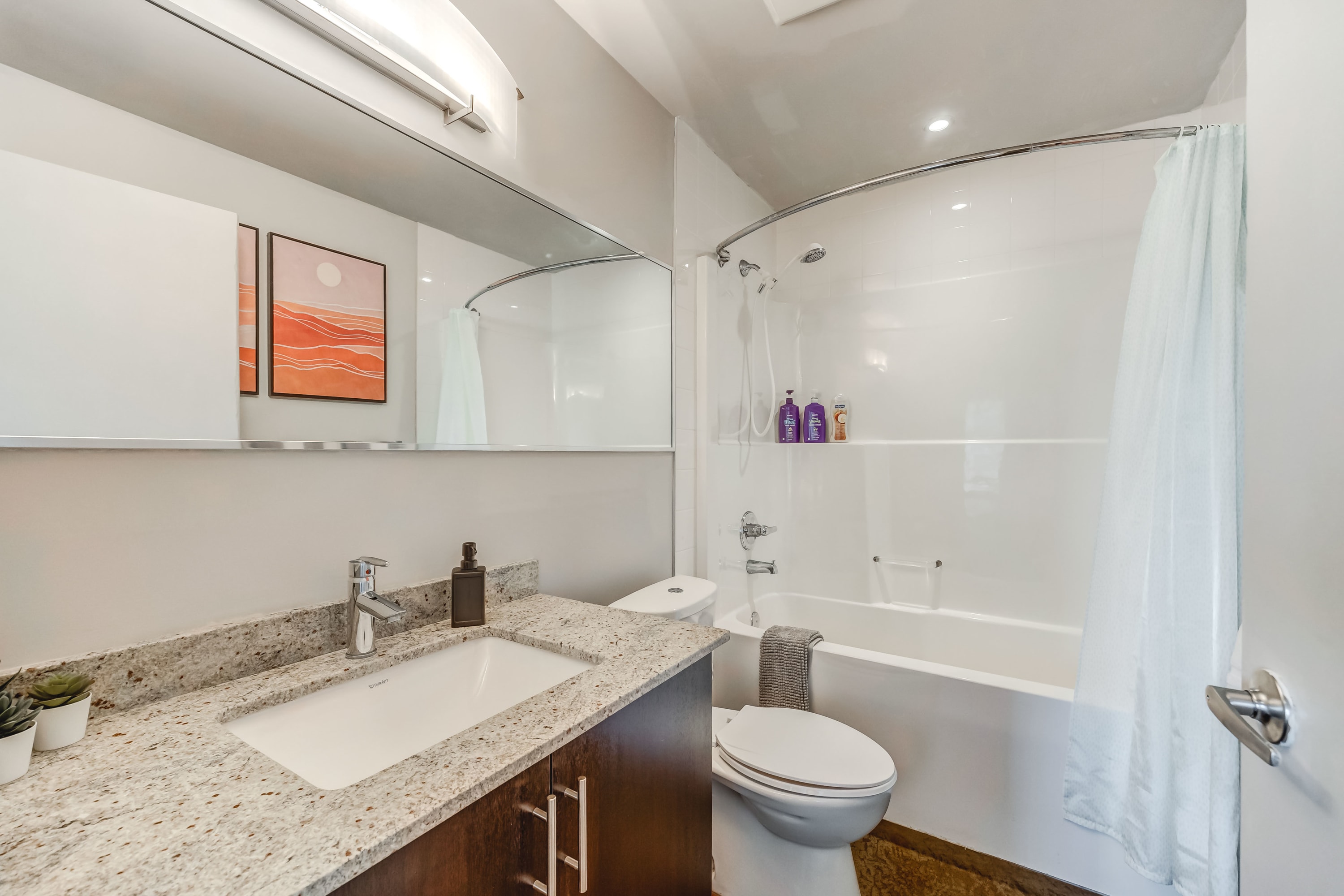 Full bathroom with combined shower and bathtub