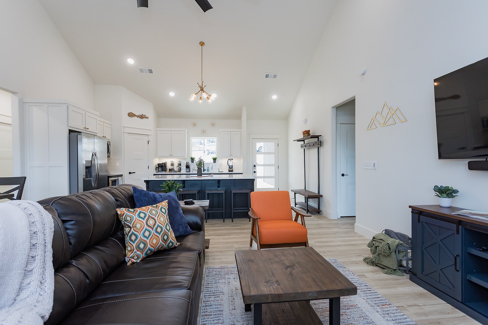 Open concept living to kitchen.