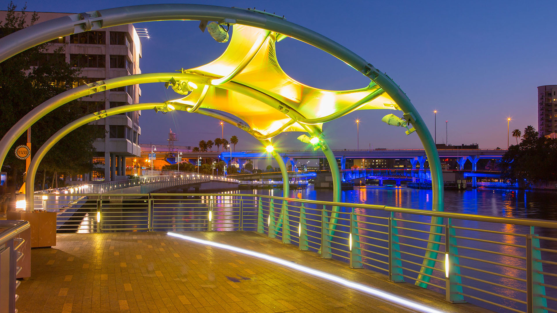 Nighttime walkway lit by vibrant colors, perfect for an evening stroll.