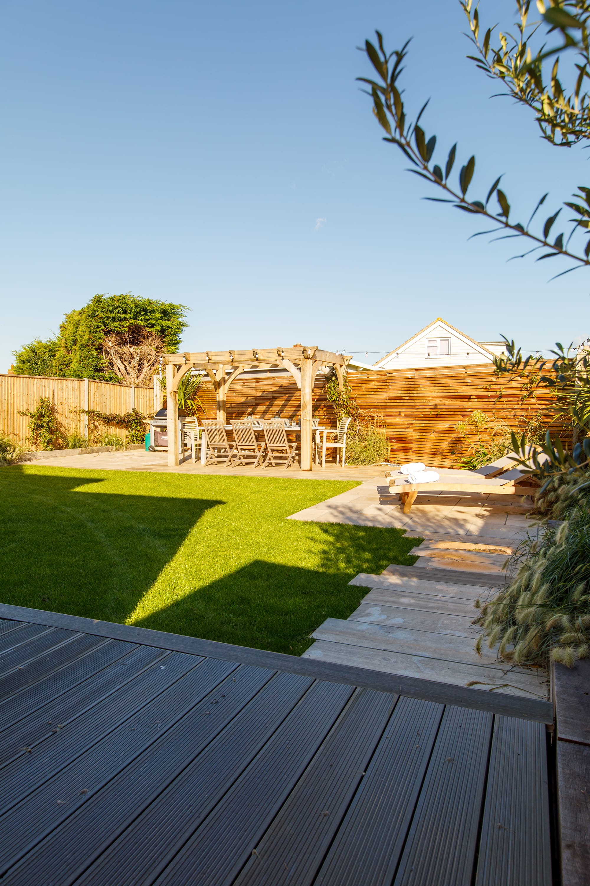 The garden is a great space combining lawn, decking and seating.