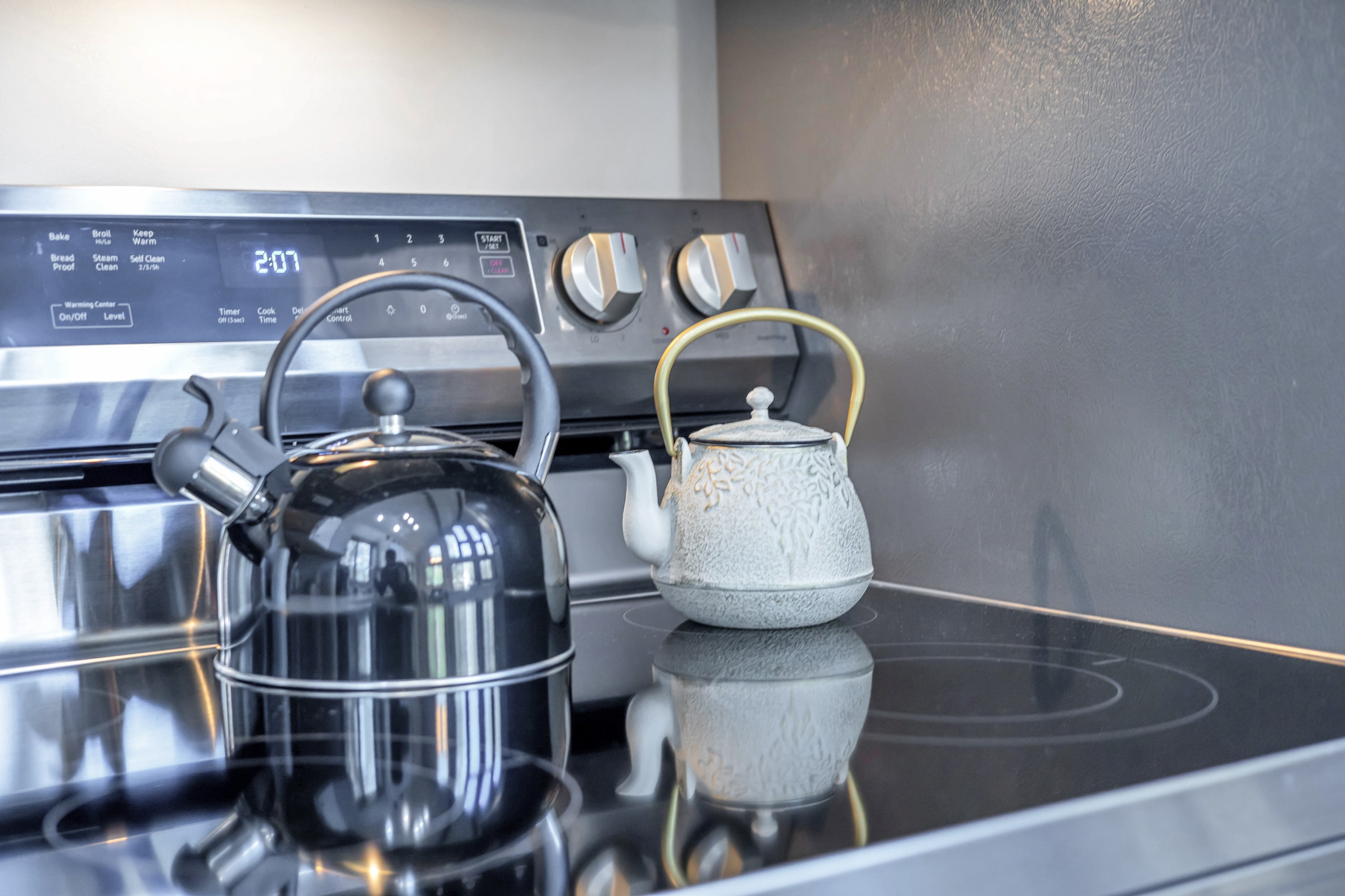 Modern kitchen with a sleek stainless steel stovetop and two kettles, perfect for brewing your favorite warm beverages.