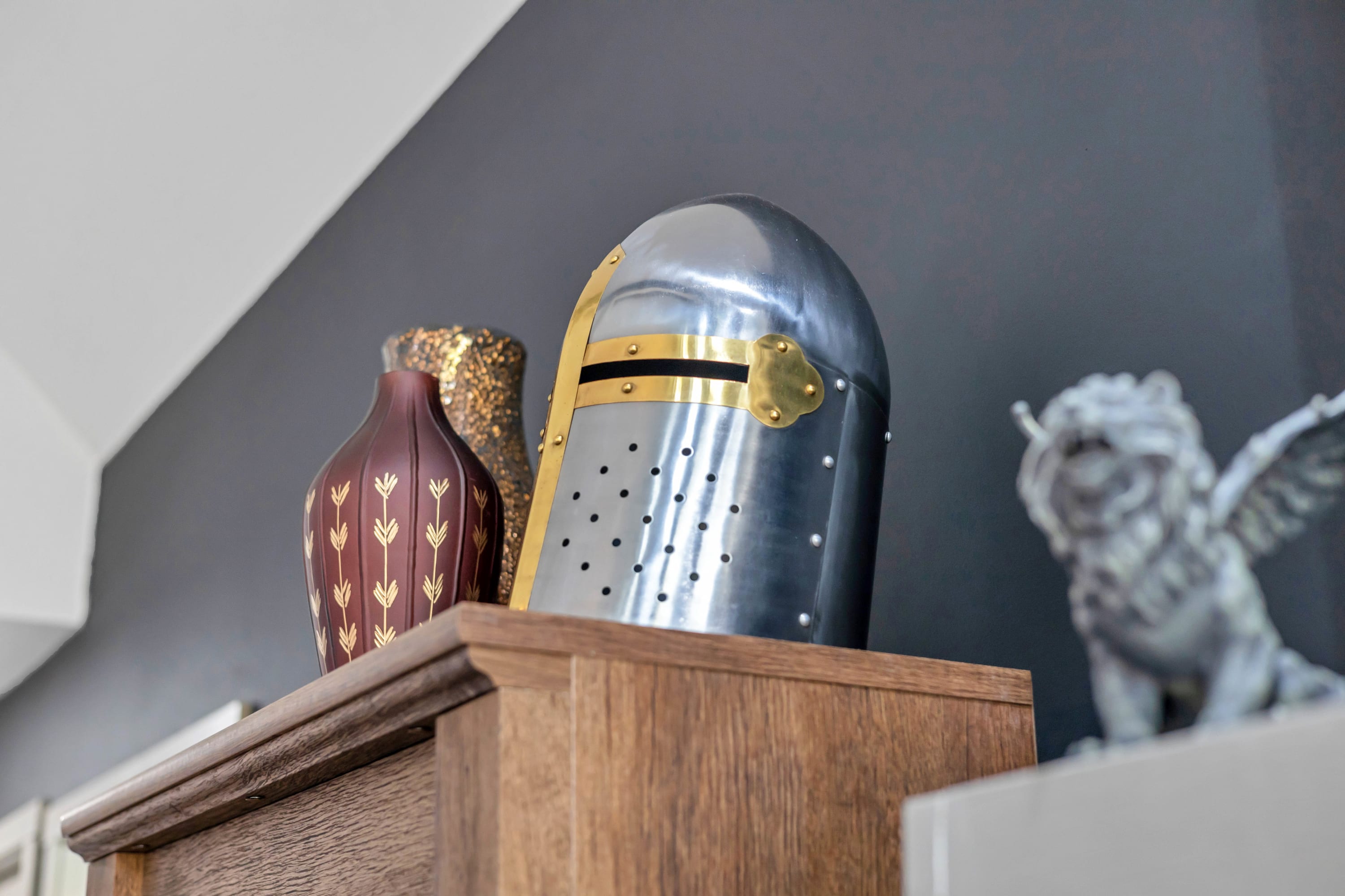 Add a touch of character to your stay with unique decorations, including a knight's helmet, vases, and a gargoyle, all part of the charming ambiance at Good Knight's Rest.