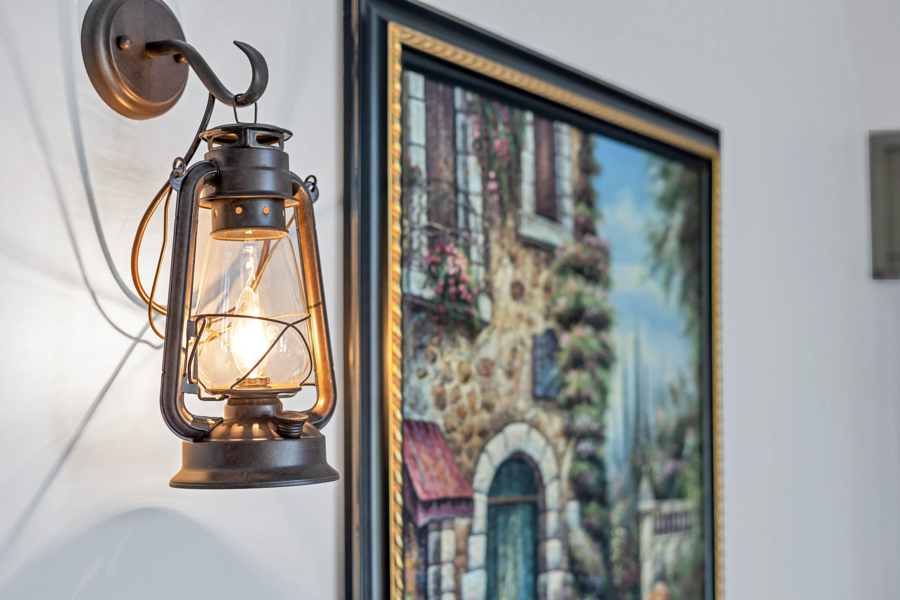 Vintage-style wall lantern casting a warm glow over a charming space.