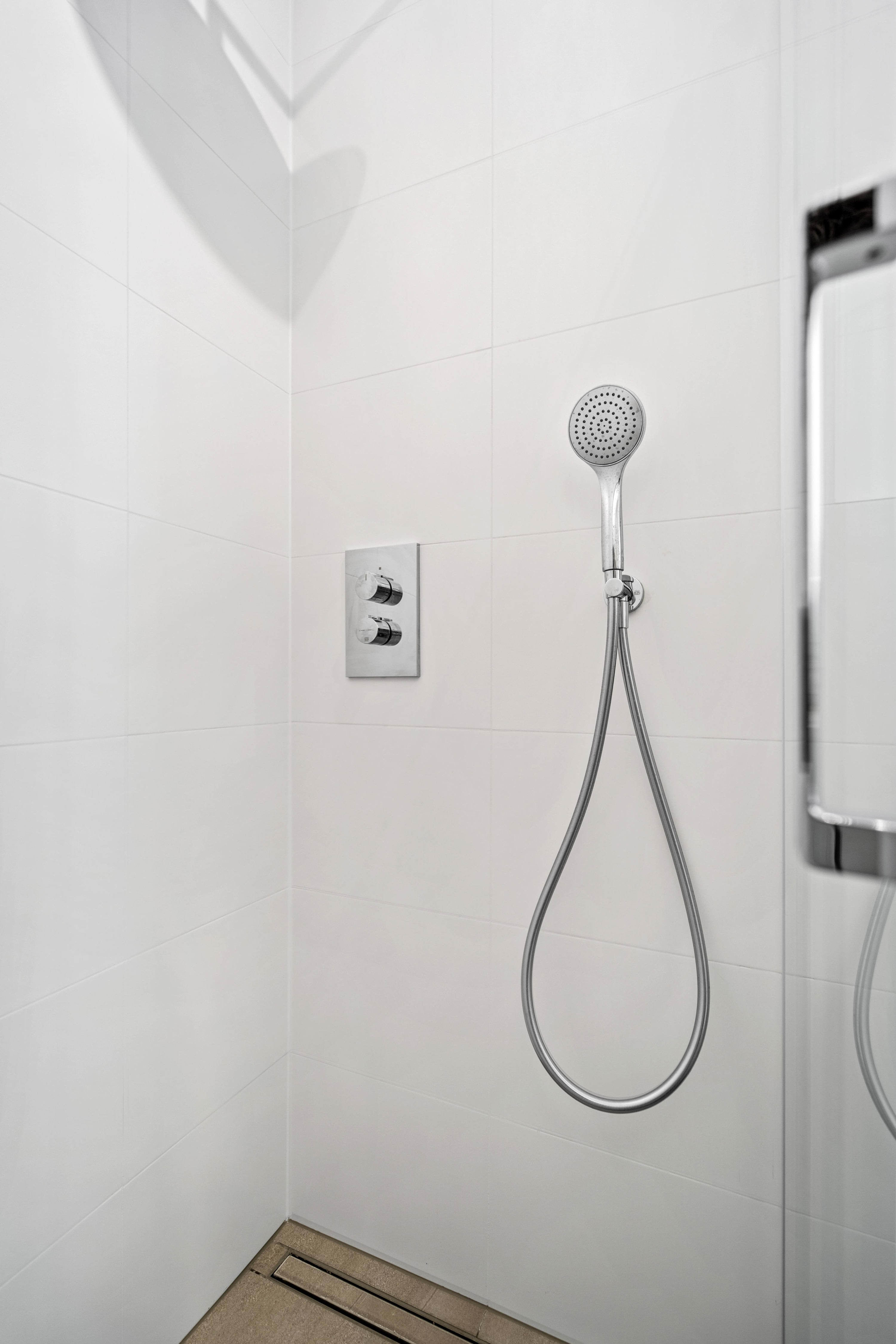 Freshen up in our sleek shower, designed for a rejuvenating experience.