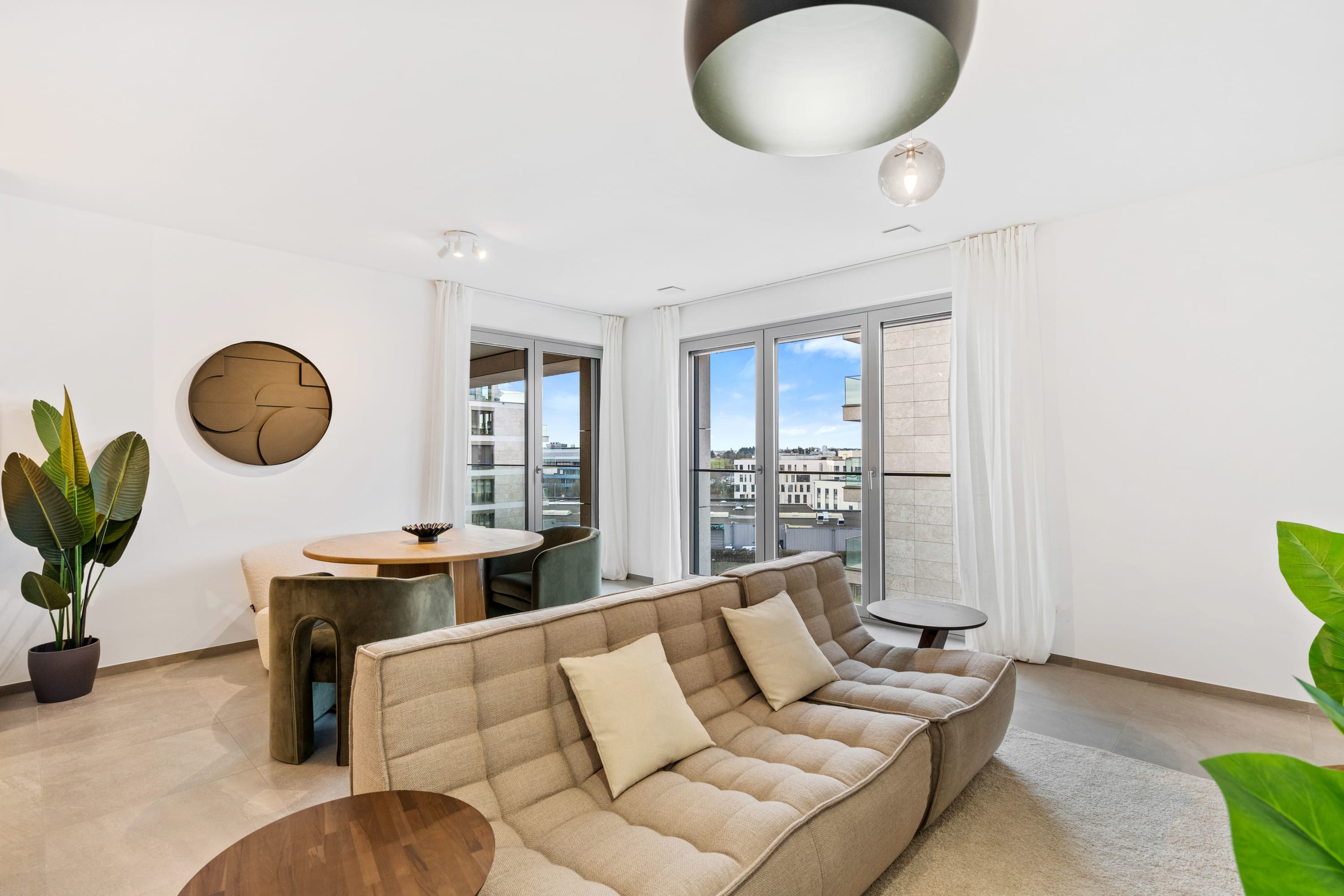 Chic comfort meets style in our inviting lounge area with a touch of greenery.
