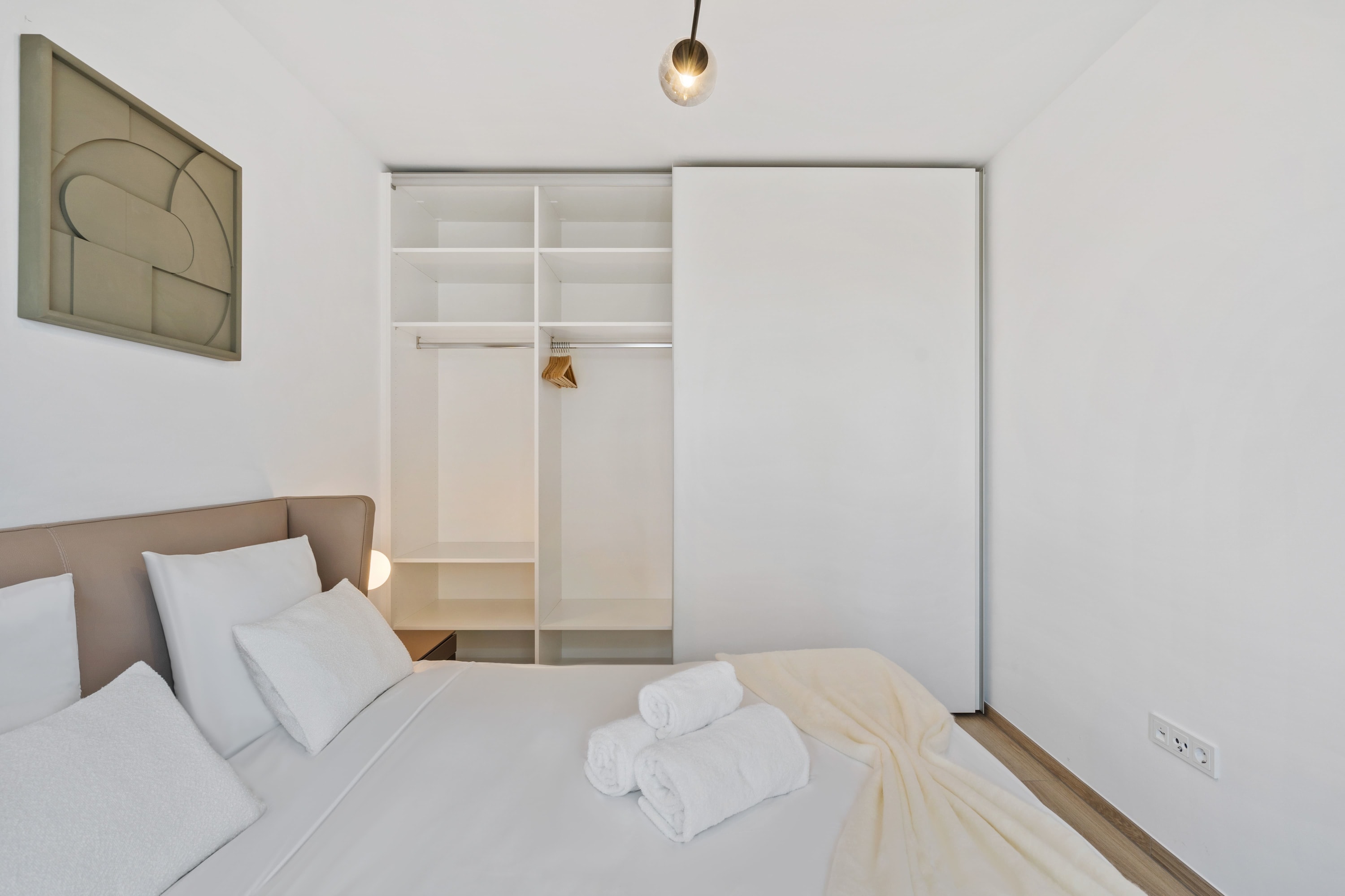 Sleek lines and soft linens: our bedroom is a haven of relaxation.