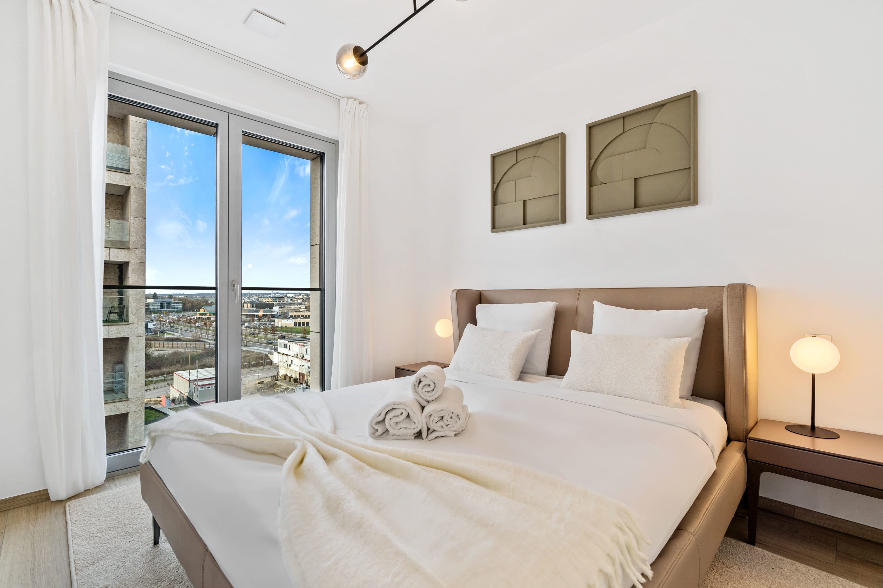 Dream away in comfort with city skyline views from your bedroom.