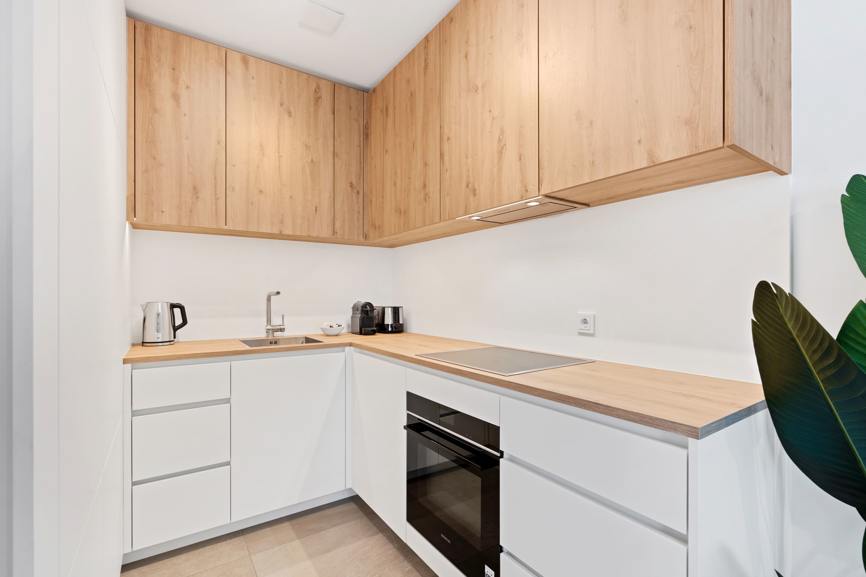 Whip up a feast in our fully equipped kitchen with sleek wooden accents.
