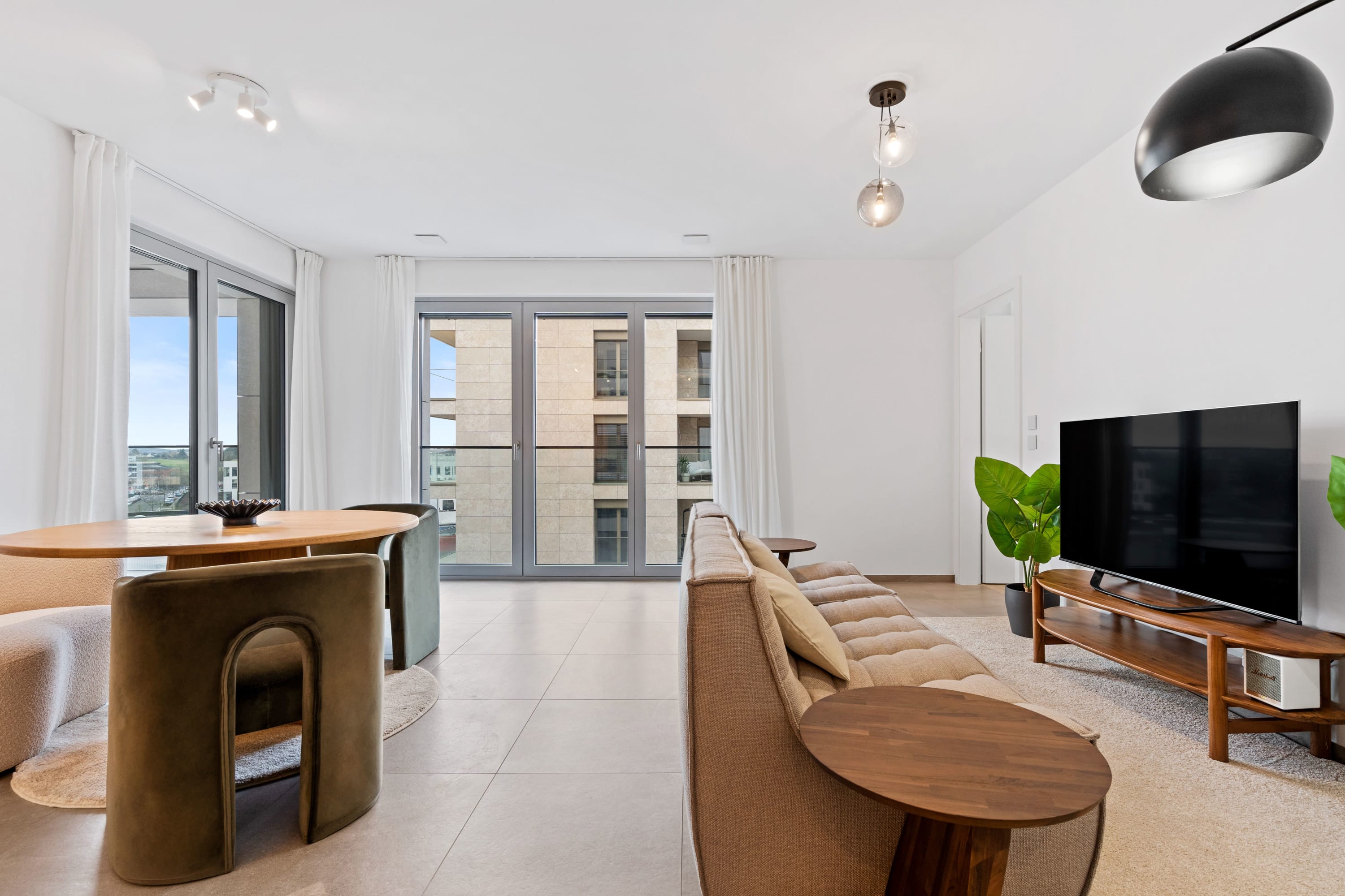 Bask in the natural light of our airy living room with expansive city views.