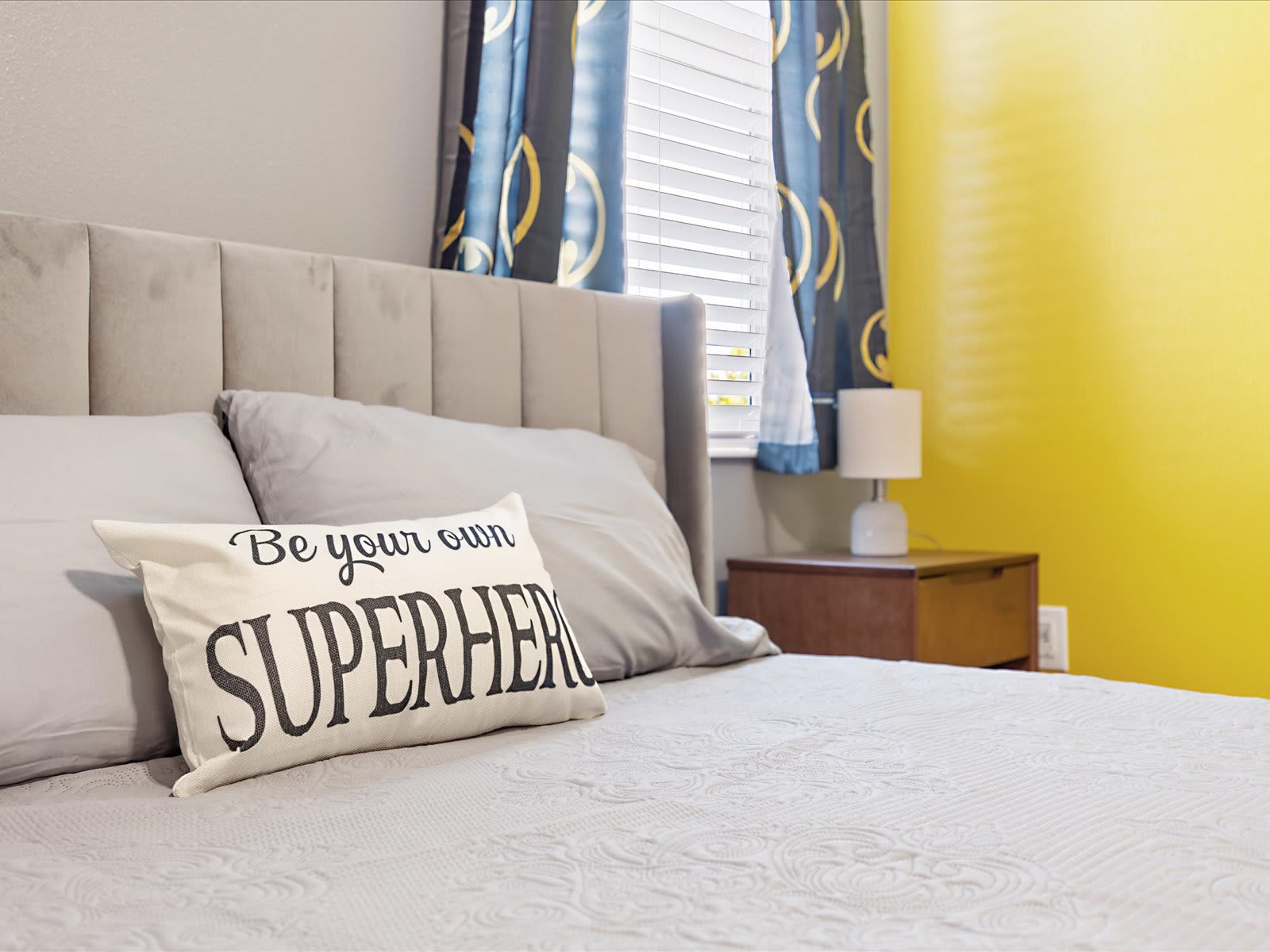 Airy bedroom w/ ceiling fan & soft tones for a calm retreat.