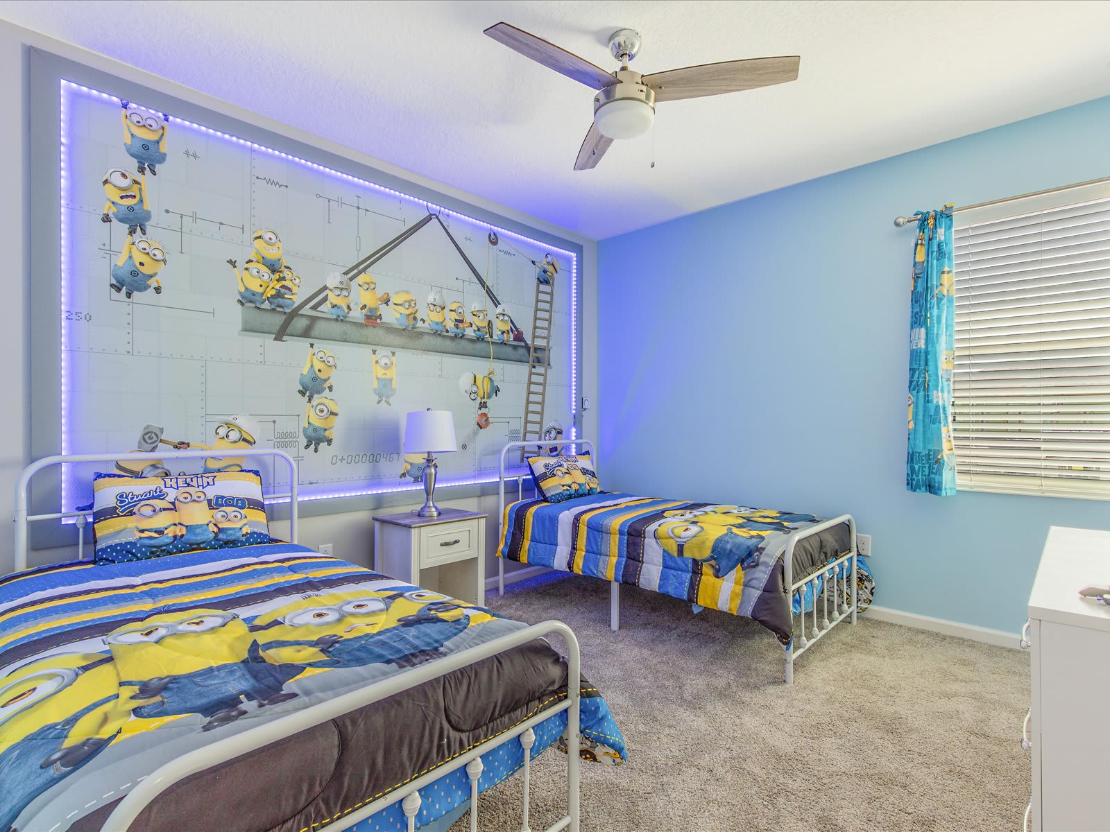 Fun kids’ room w/ twin beds & playful themed bedding.
