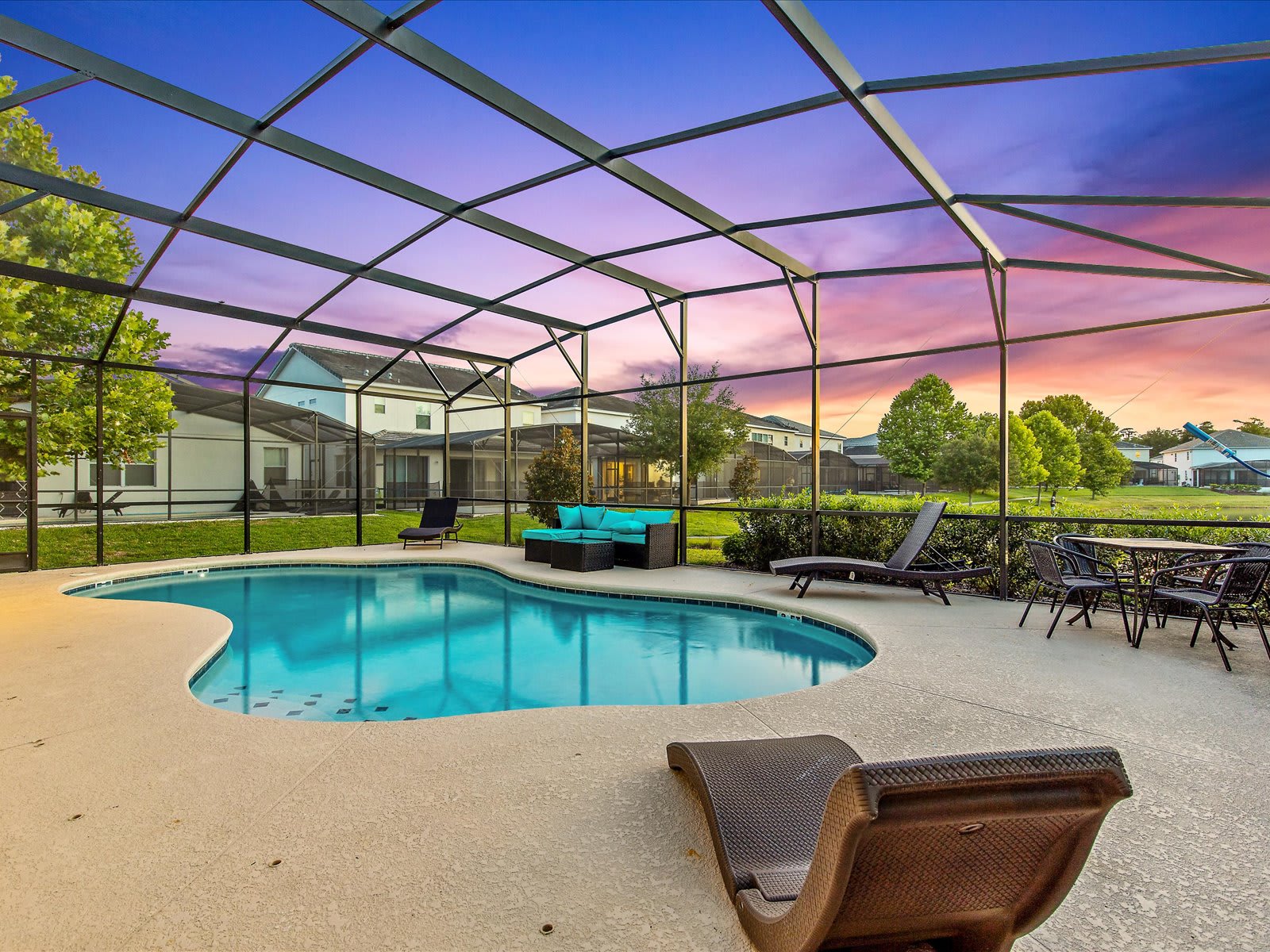 Spacious screened pool area w/ loungers for laid-back sunny days.