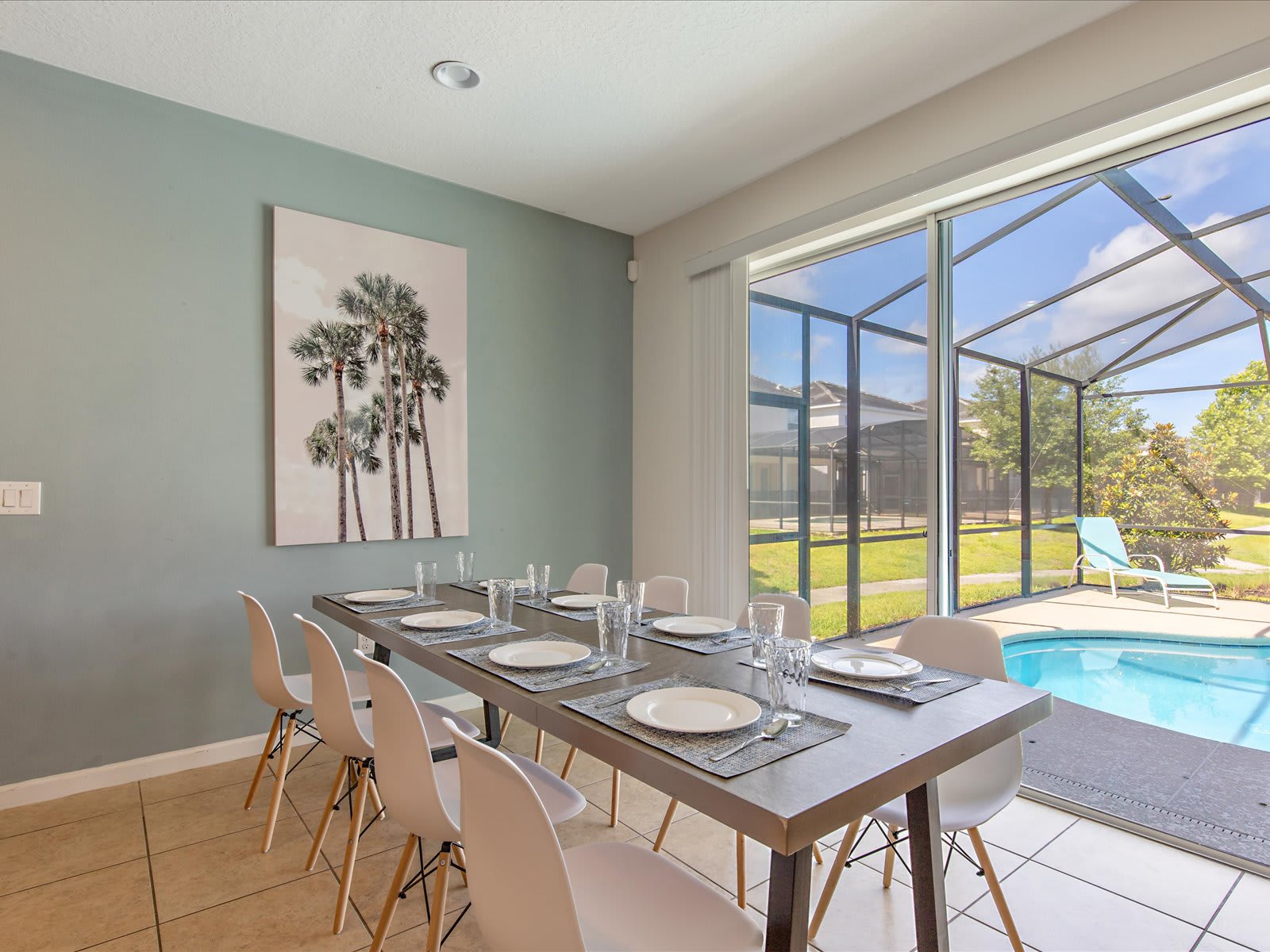 Sunlit dining area w/ large table, perfect for shared meals.