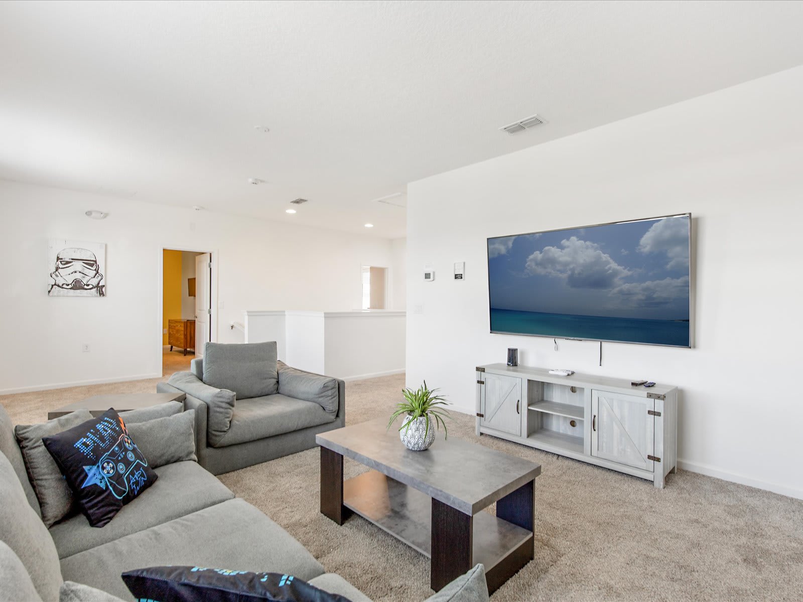 Bright living room w/ sectional seating & TV for relaxed downtime.