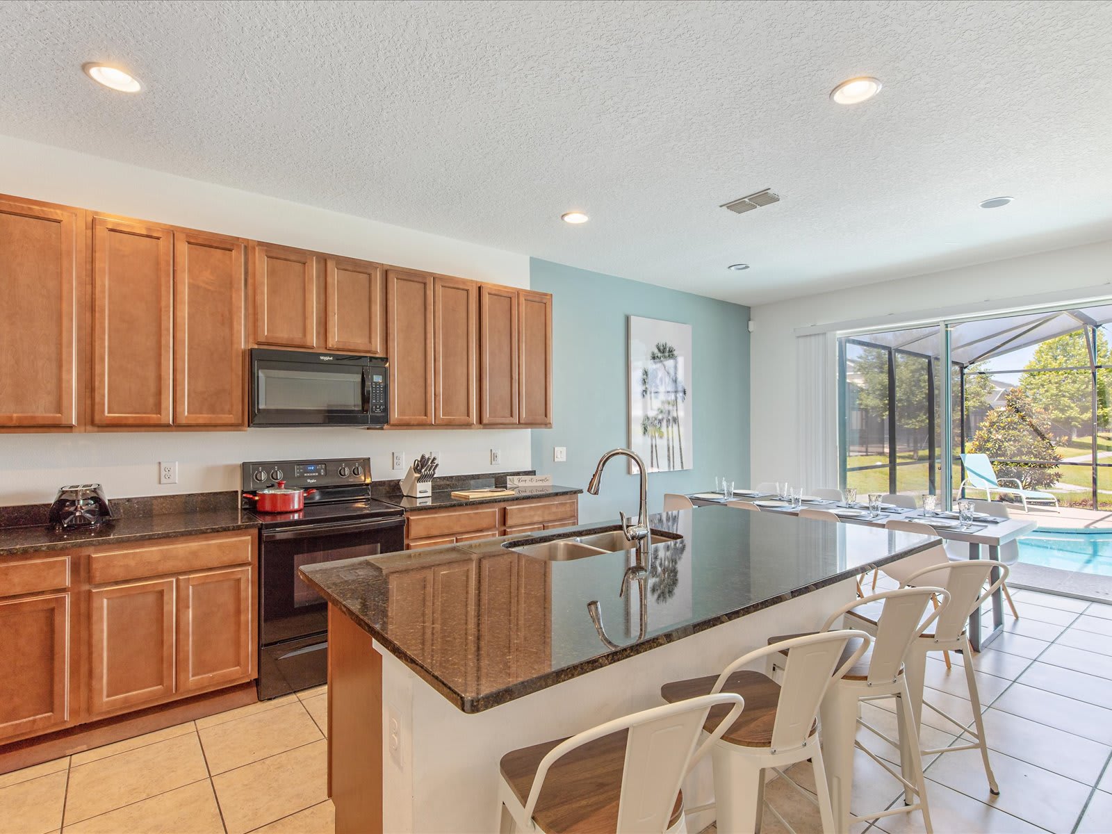 Open kitchen island w/ seating, ideal for casual meals & conversation.