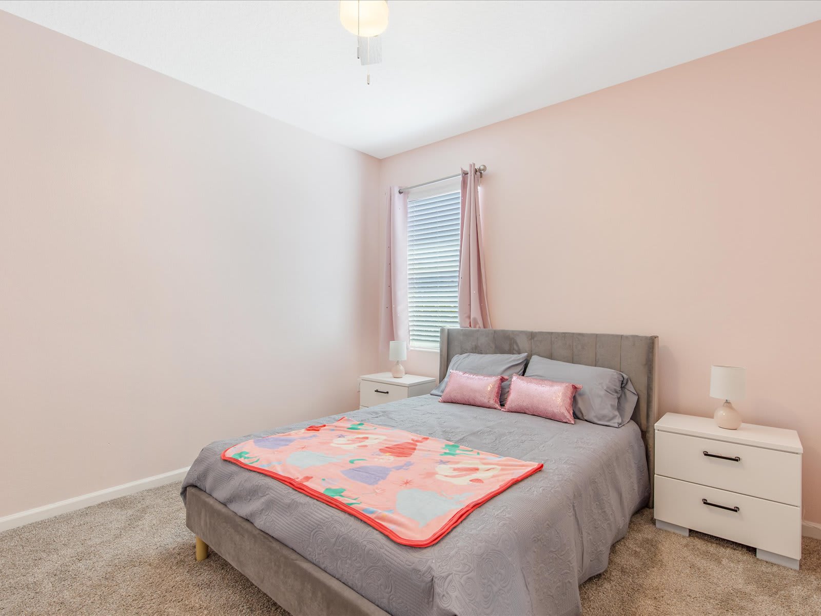 Soft-toned bedroom w/ plush bedding & a calm, welcoming feel.