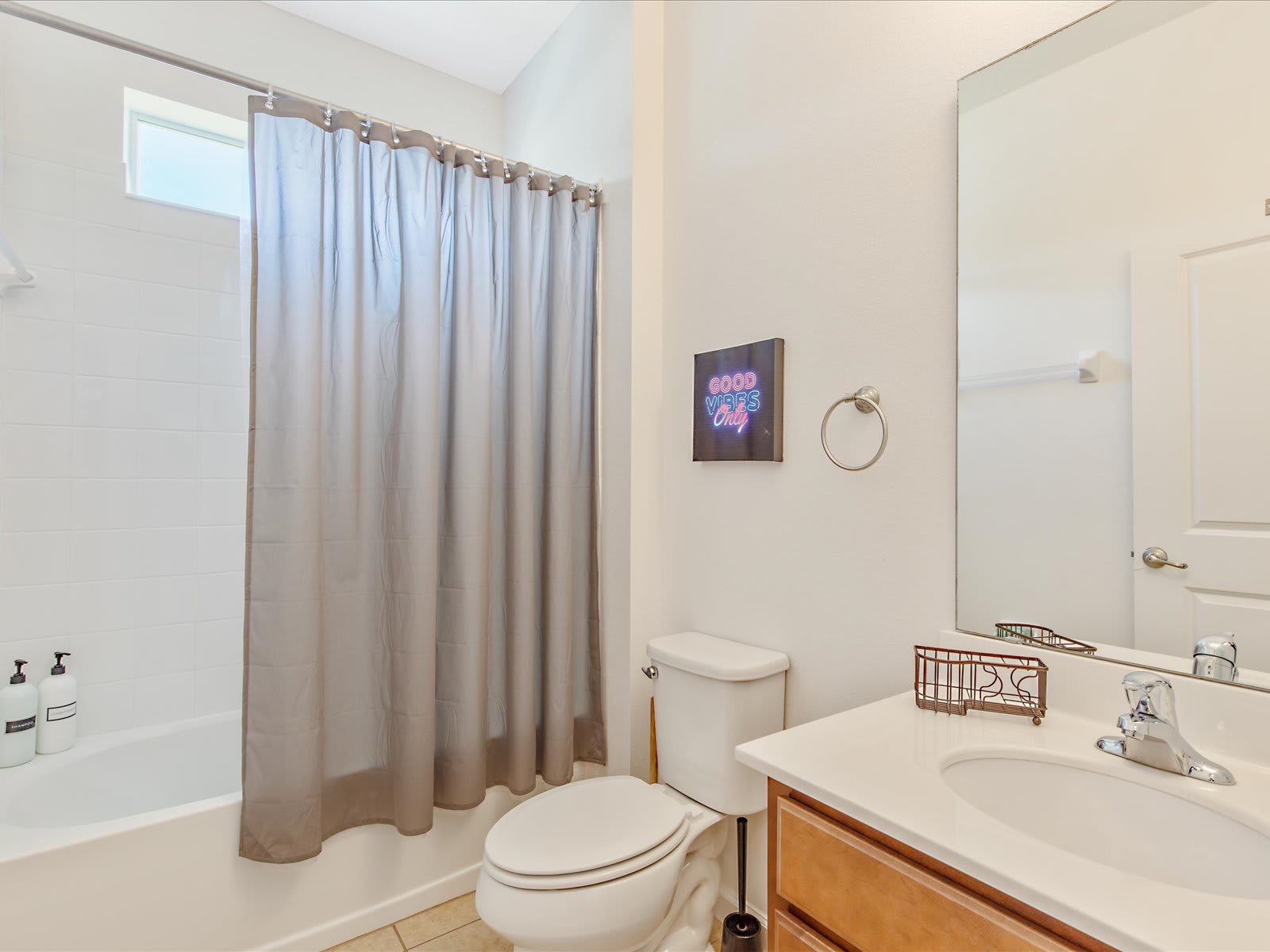 Clean bathroom w/ sink, mirror, & tub/shower combo in a bright layout.