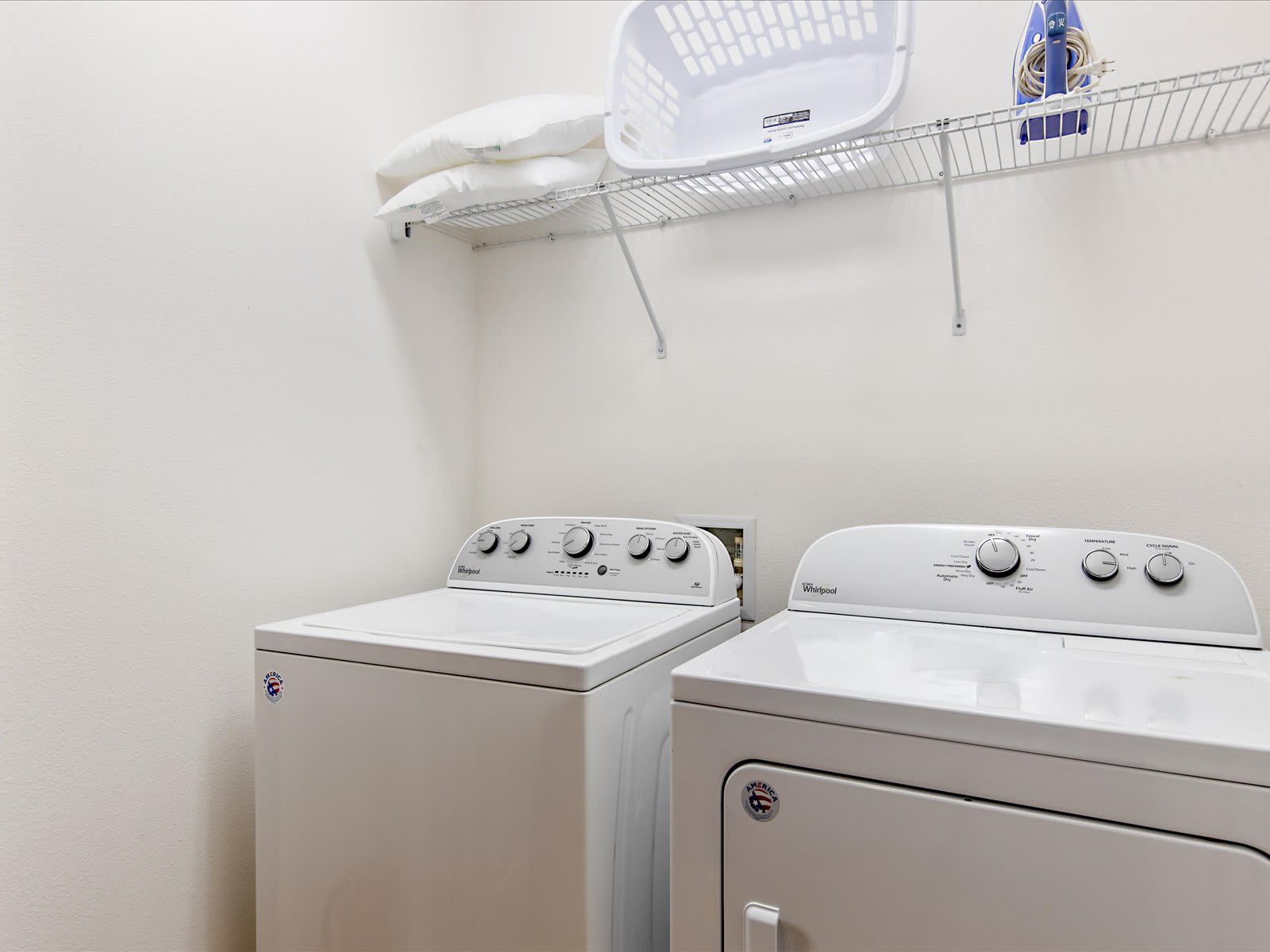Convenient laundry area w/ washer, dryer, & shelf storage.