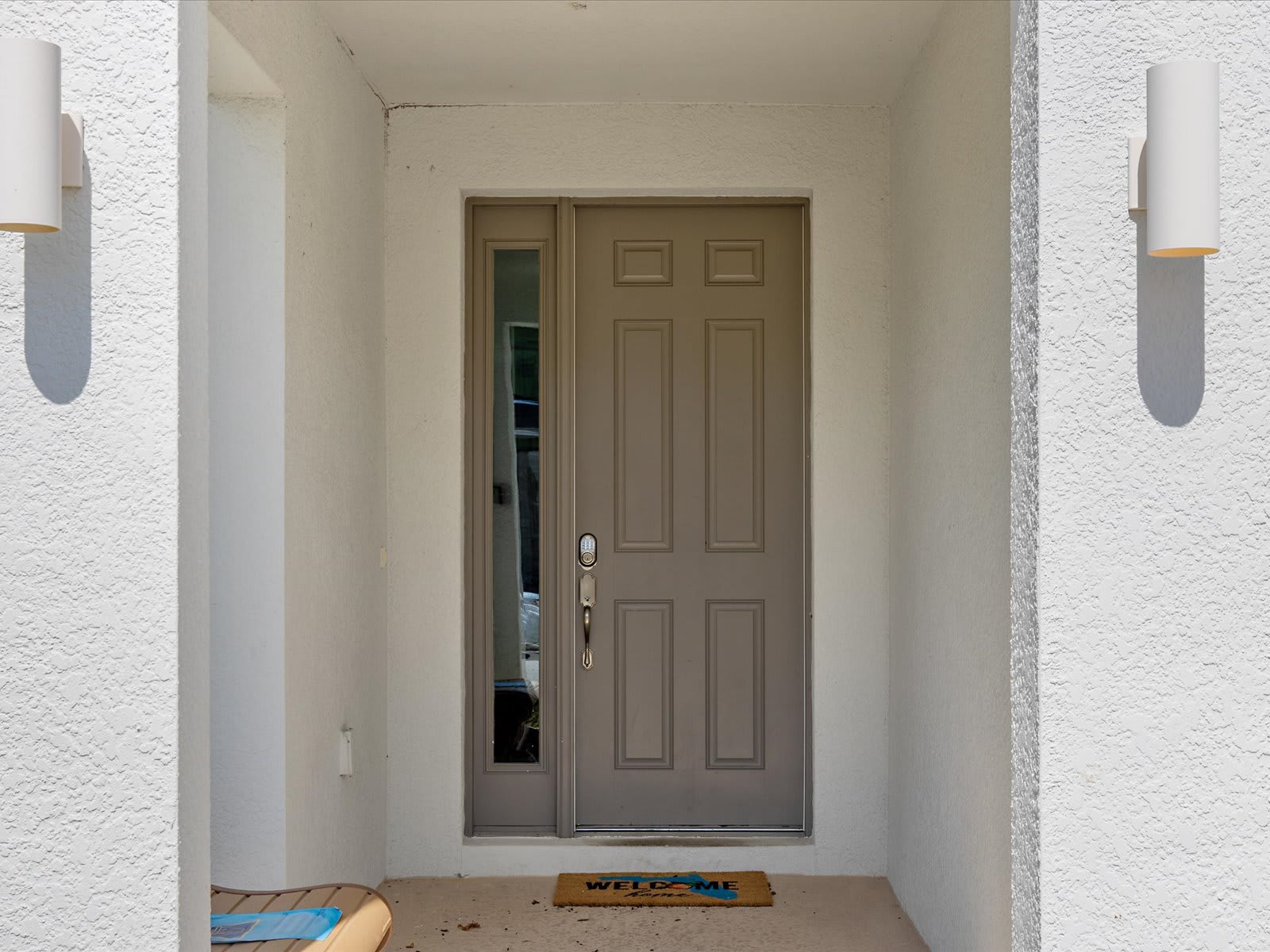 Welcoming front entry w/ covered porch & simple, clean design.