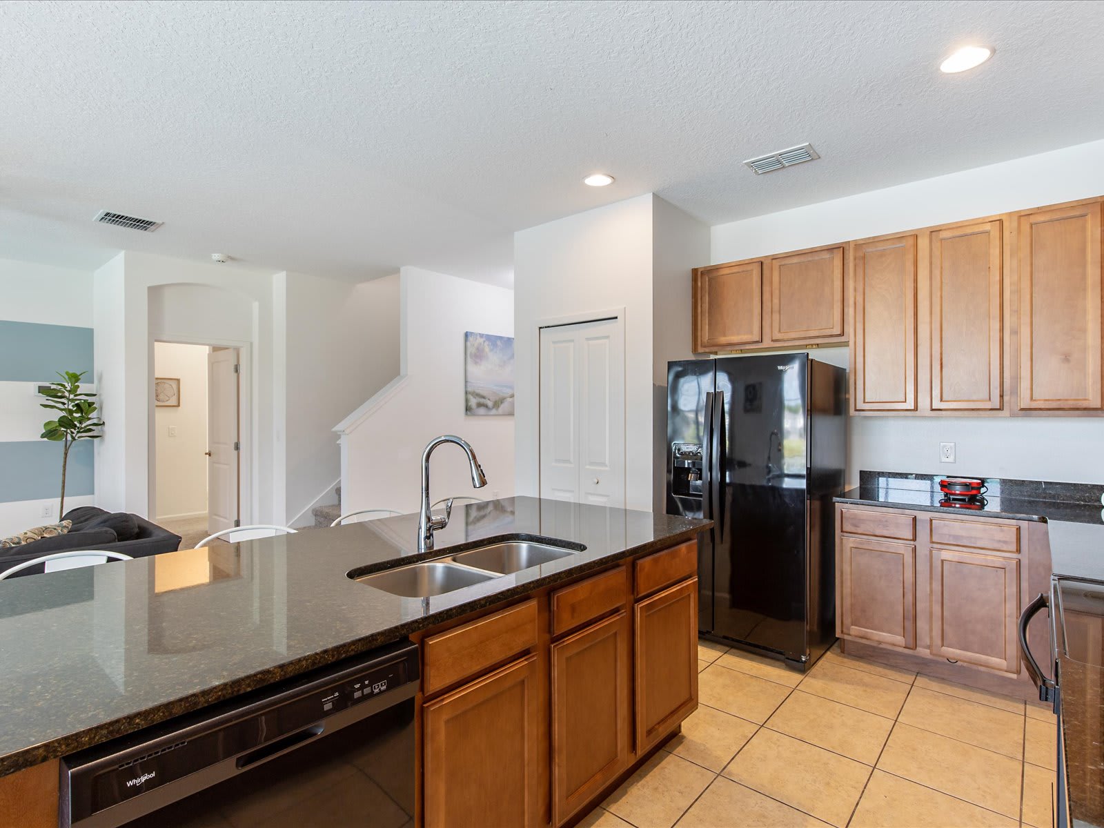 Open kitchen w/ granite island, stainless appliances, & plenty of prep space.