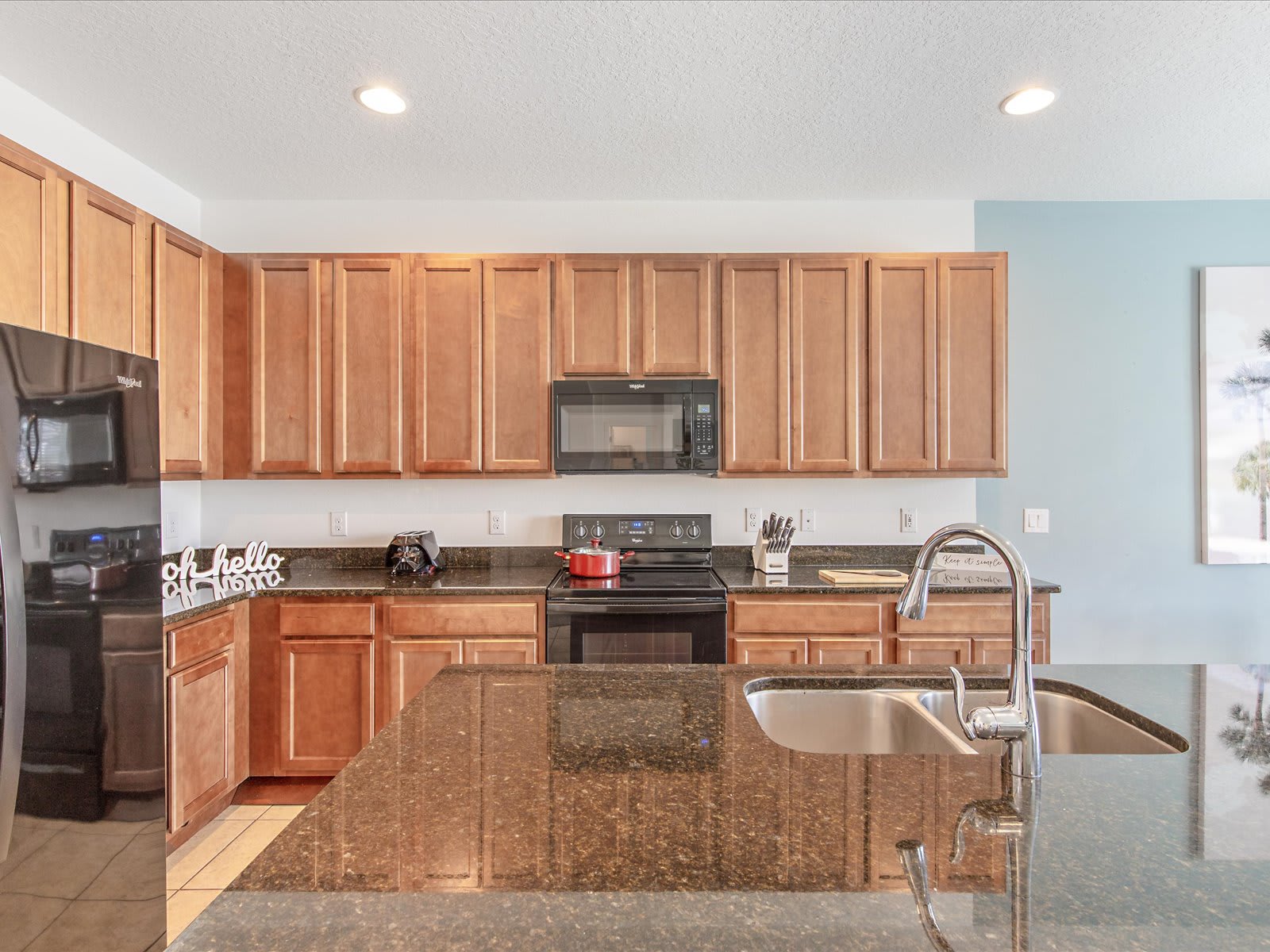 Spacious kitchen w/ granite counters, ample cabinets, & modern appliances.