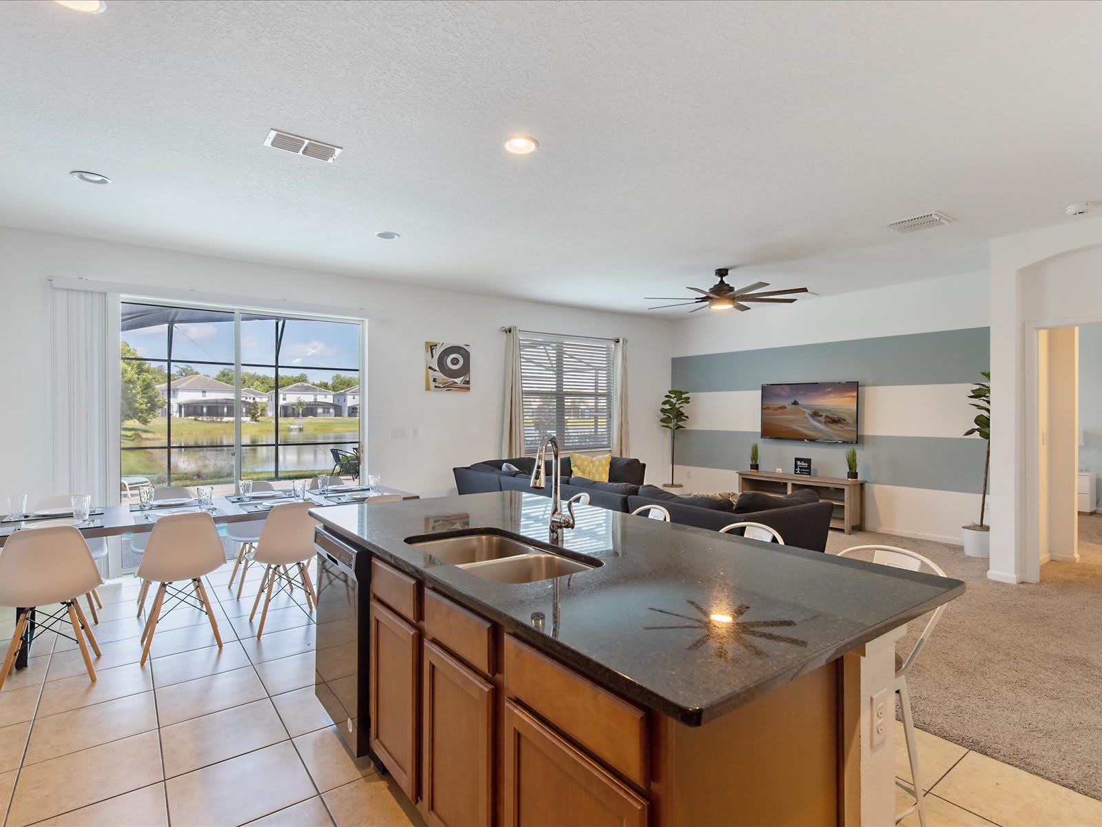 Bright open layout w/ kitchen island flowing into dining & living areas.