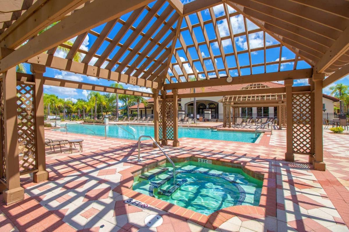 Inviting hot tub under a shaded pergola, ideal for unwinding outdoors.