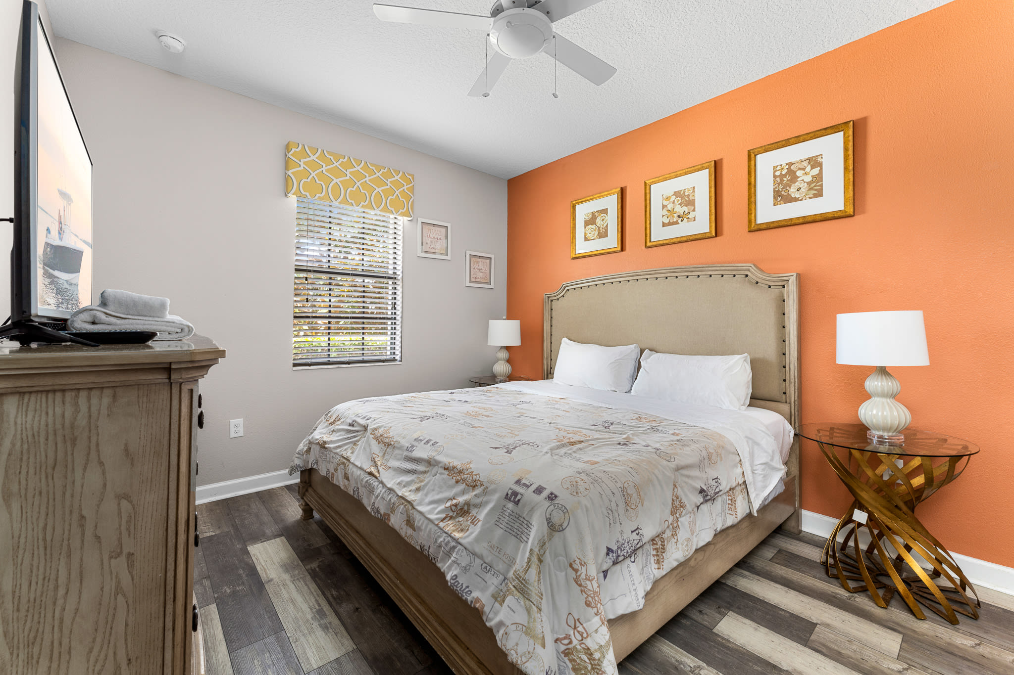 Inviting bedroom w/ accent wall and layered textures for extra comfort.