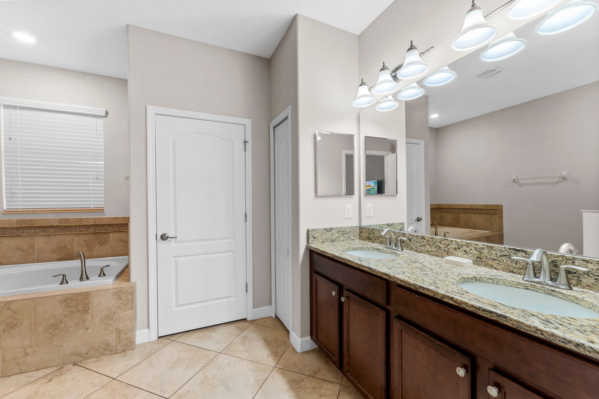 Bathroom vanity w/ granite counter and sink, offering plenty of space to get ready.