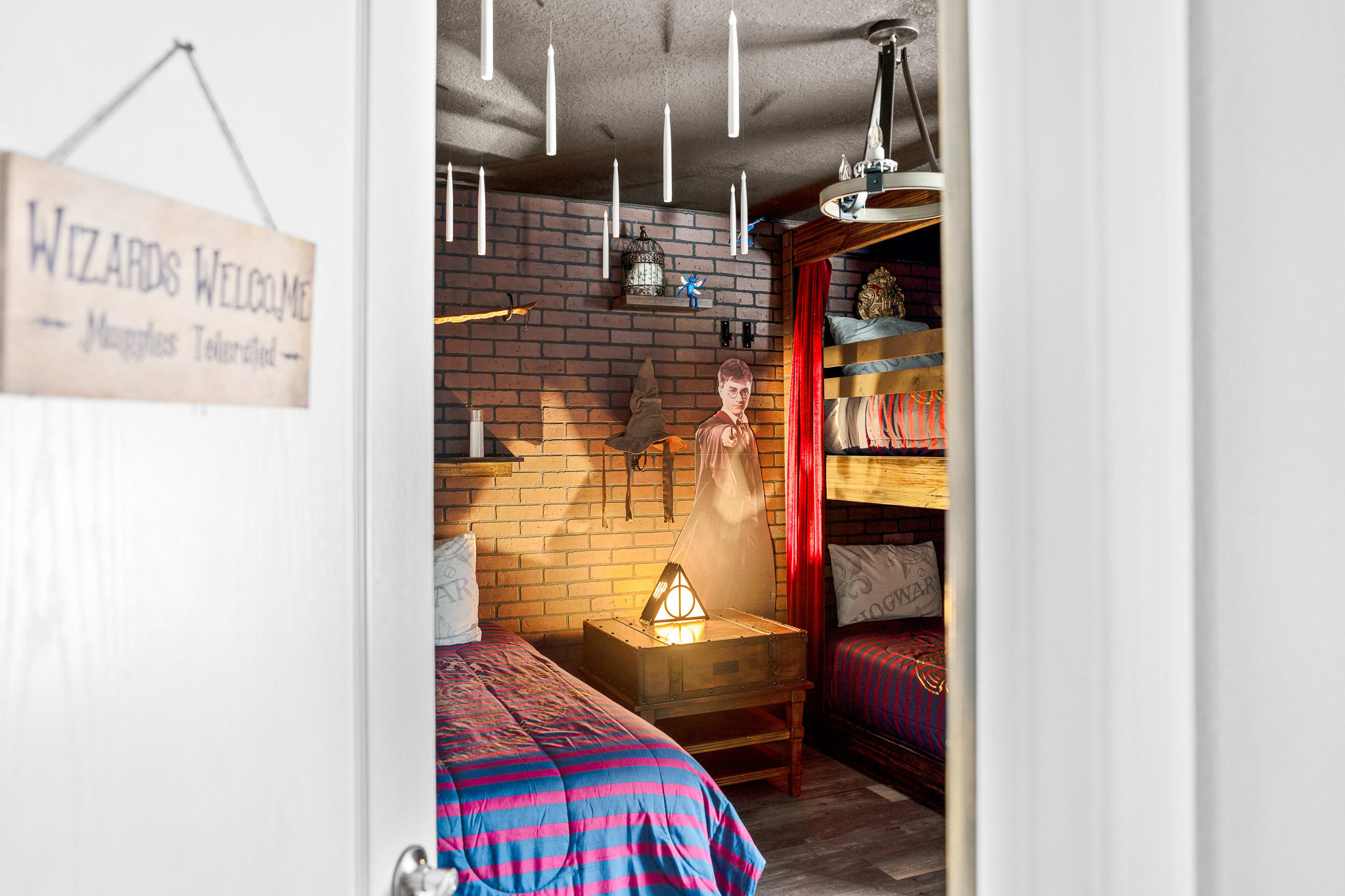Hallway accented w/ art and warm lighting for a welcoming feel.