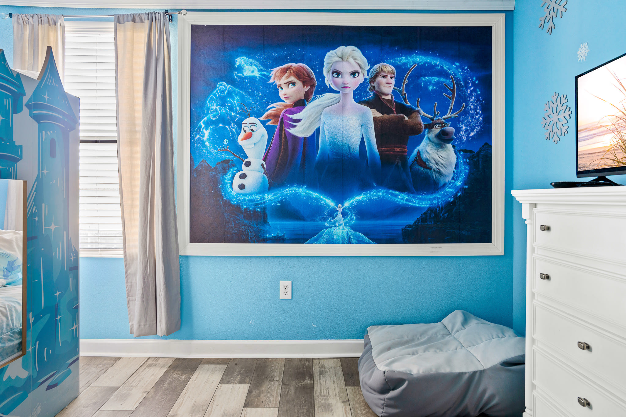 Statement wall mural creating a playful, memorable room design.