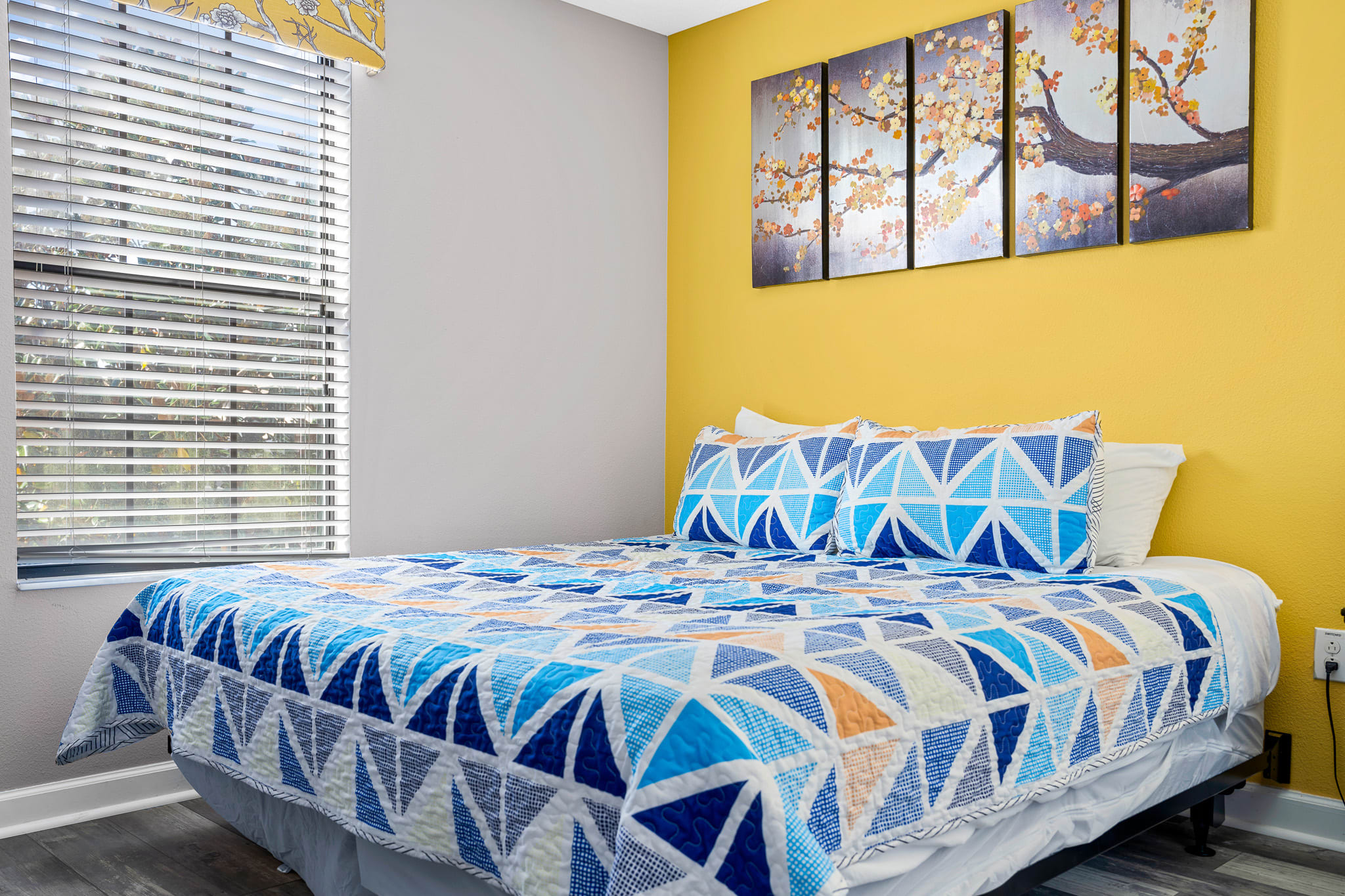 Colorful bedroom w/ playful bedding and a cheerful, welcoming feel.