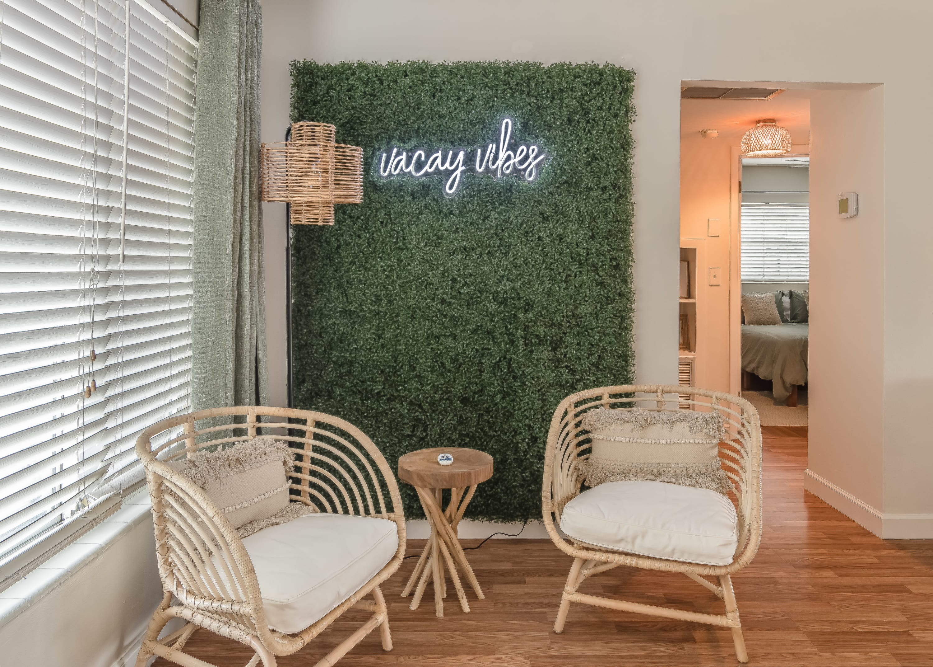 Welcoming entry nook w/ woven chairs and relaxed coastal vibes