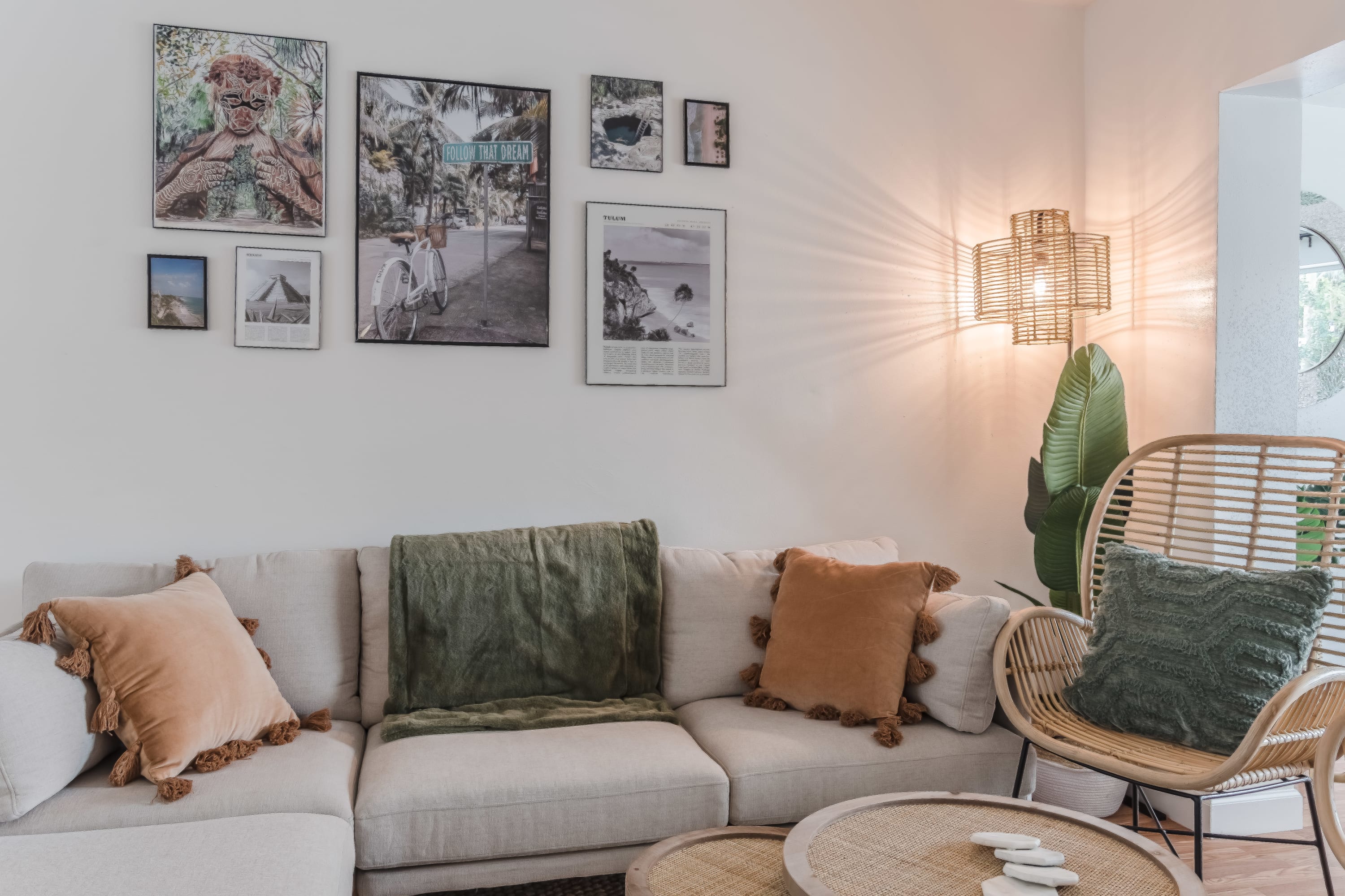 Living room sofa w/ pillows and wall art creating a homey feel